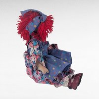 Vintage Porcelain Clown Doll, 9" Sitting Jester with Red Yarn Hair, Collectible Shelf Sitter Doll in Floral Star Dress
