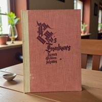 A dark hardcover book with a textured surface. The front cover features stylized black hand-lettered titles. The binding is sturdy, though the cover shows minor age-related markings, and the interior reveals powerful modernist silhouette illustrations in black and white.