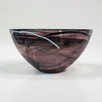 A large, deep art glass bowl featuring a clear crystal body with opaque white calligraphic swirls suspended within the glass. The bowl has a smooth, slightly flared rim and a heavy, solid base.