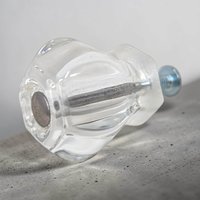 A glass cabinet knob with a rounded, mushroom-style silhouette. The glass is transparent and faceted at the base, resting on silver-tone metal hardware with mounting screws included.