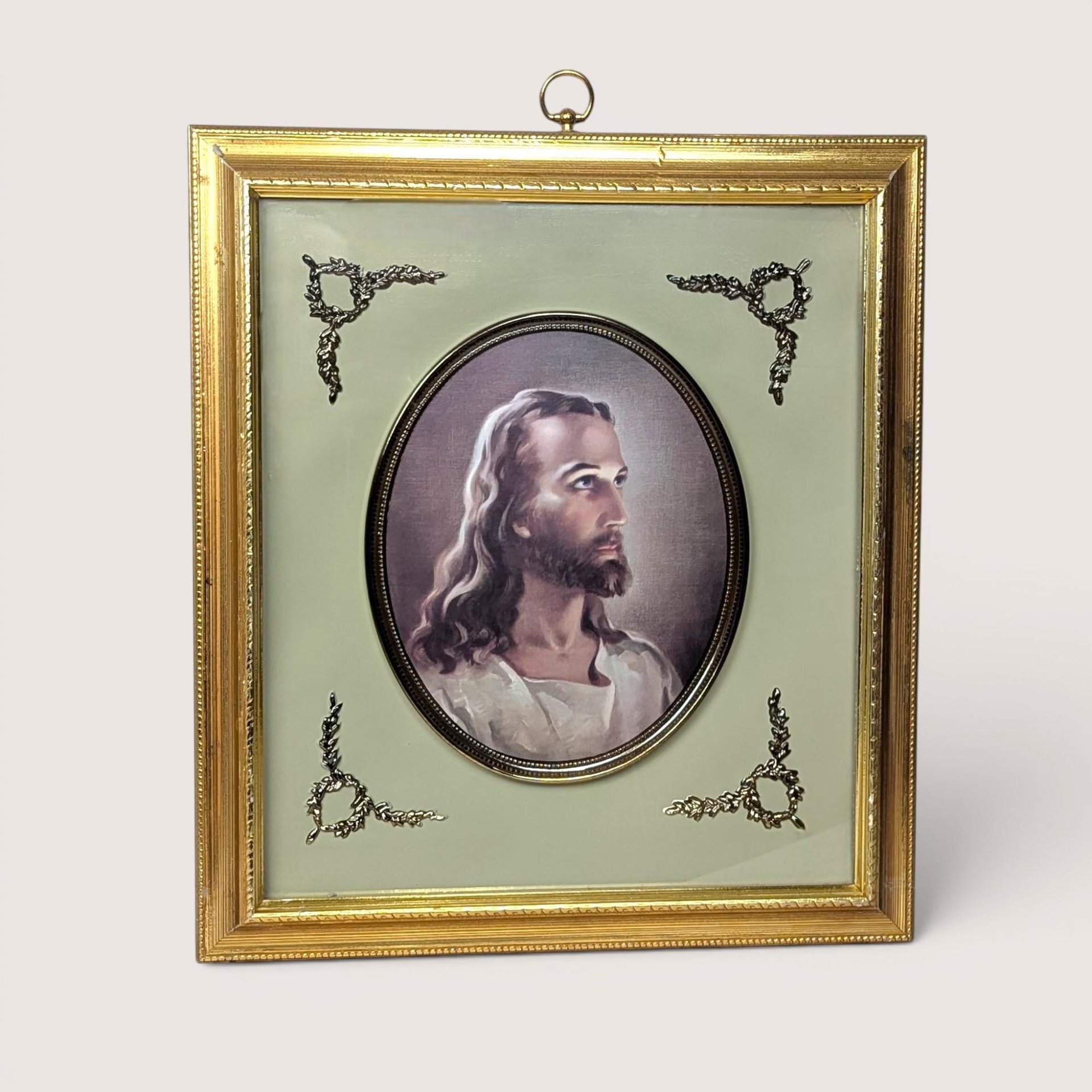 Framed Warner Sallman Head of Christ portrait in an oval matte with decorative corner flourishes and a gold frame.