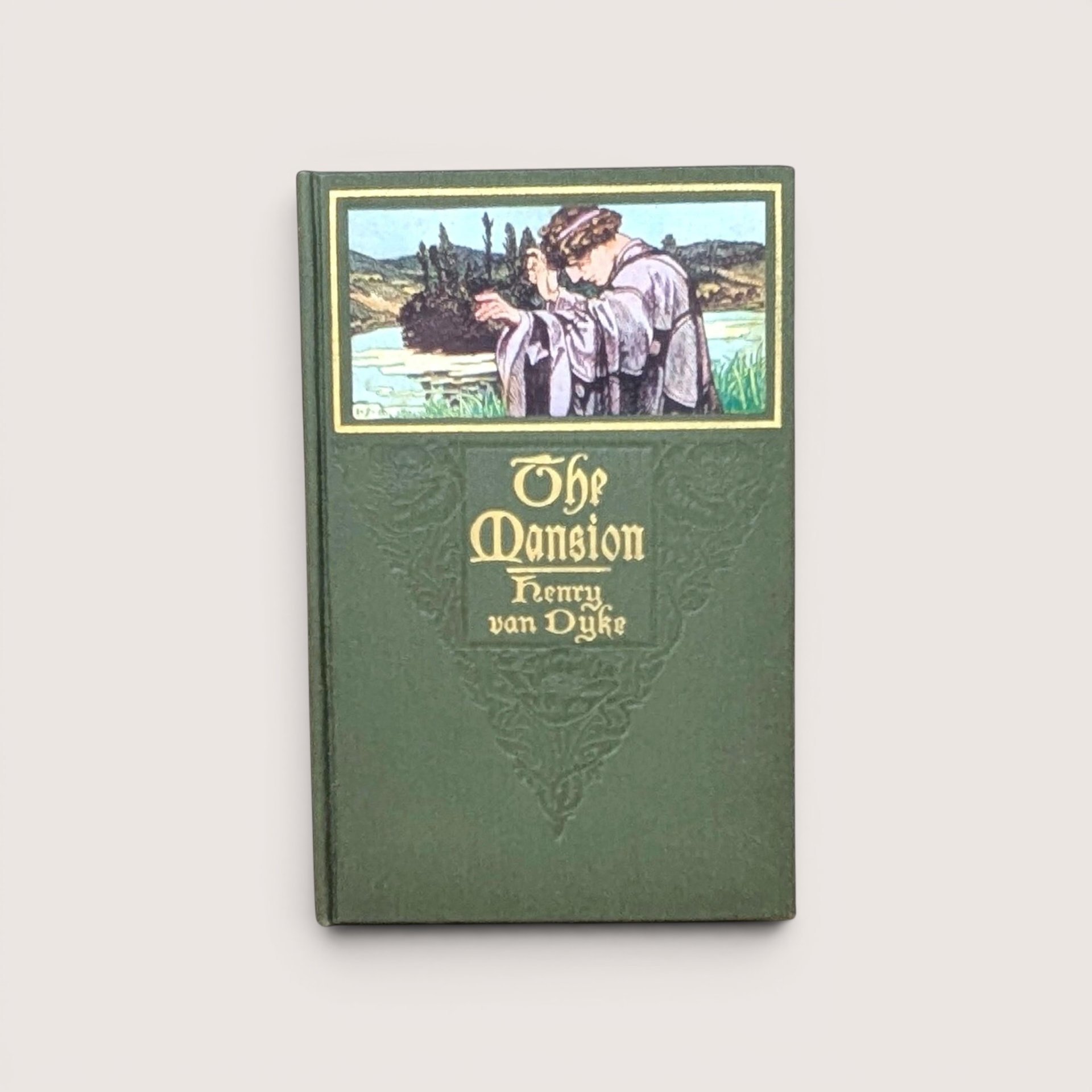 Vintage green cloth hardcover book with gold gilt lettering and inset illustration of a robed figure by a river