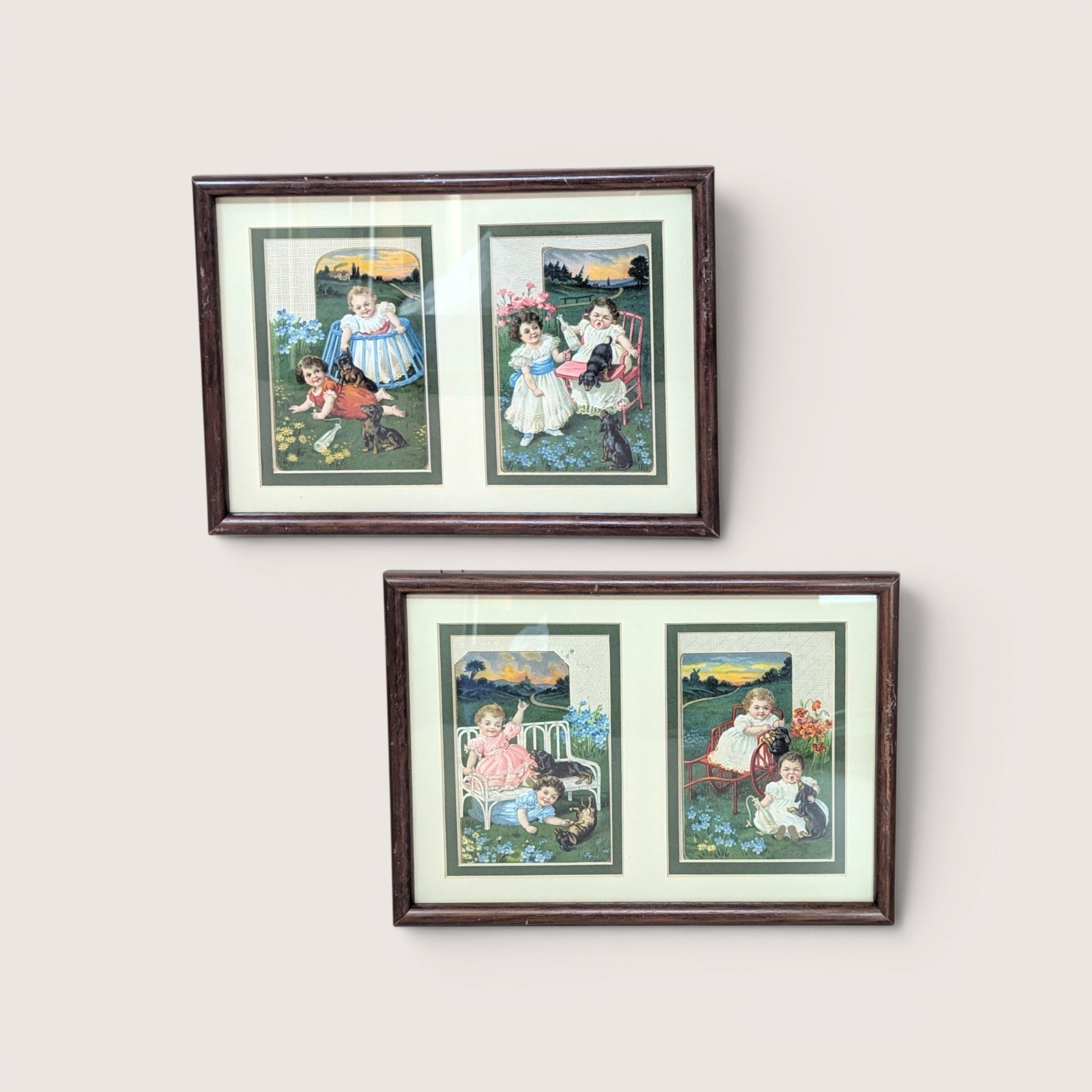 A set of two framed wall hangings, each containing two vintage-style advertising cards featuring Victorian children and puppies in pastoral outdoor settings.