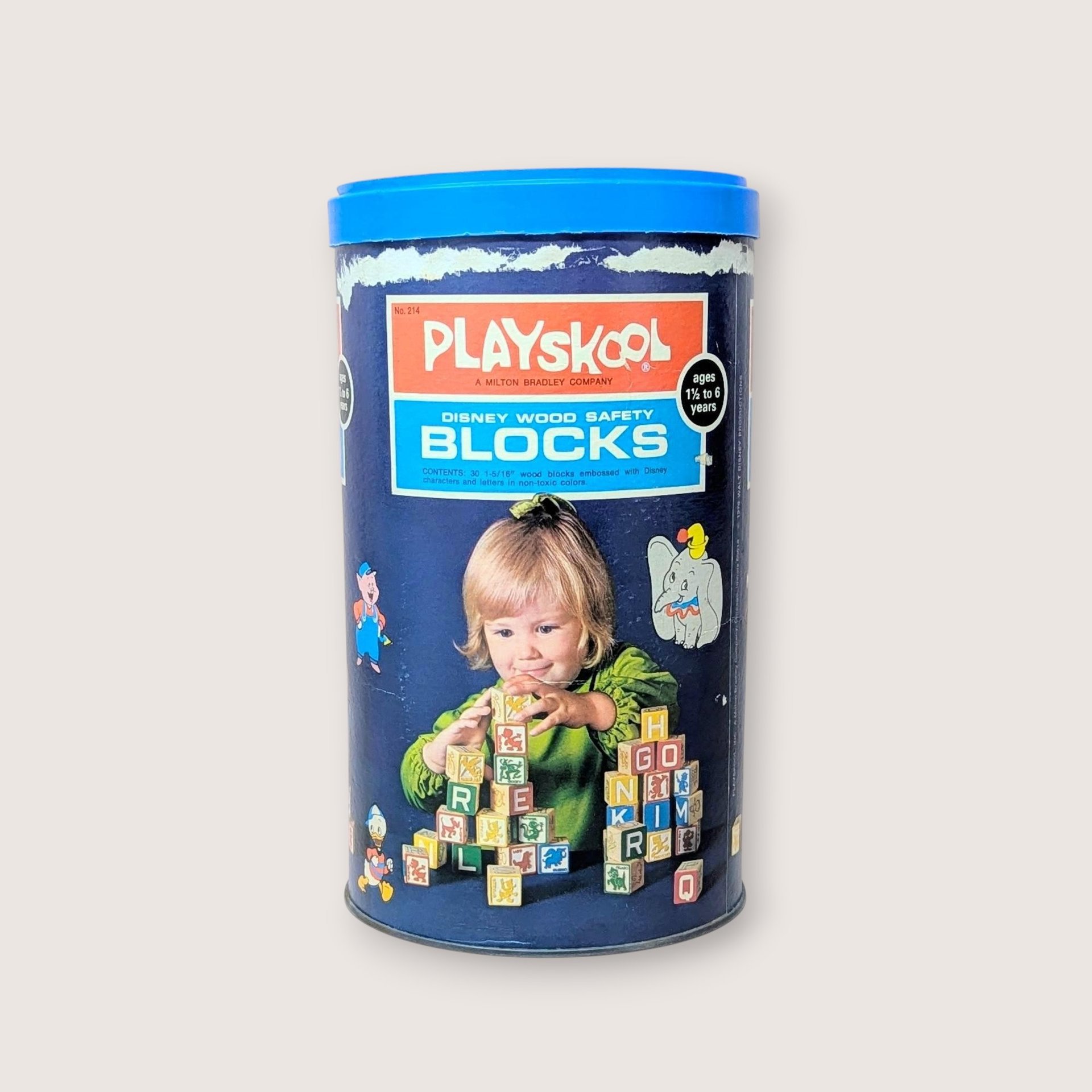 A vintage navy blue Playskool canister for Disney Wood Safety Blocks featuring a child playing with blocks and various Disney character graphics