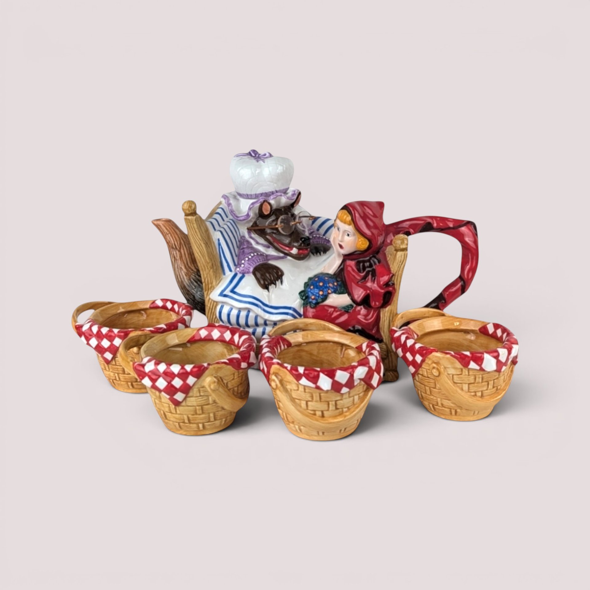 Department 56 Little Red Riding Hood ceramic teapot with wolf in bed and four matching basket weave tea cups.