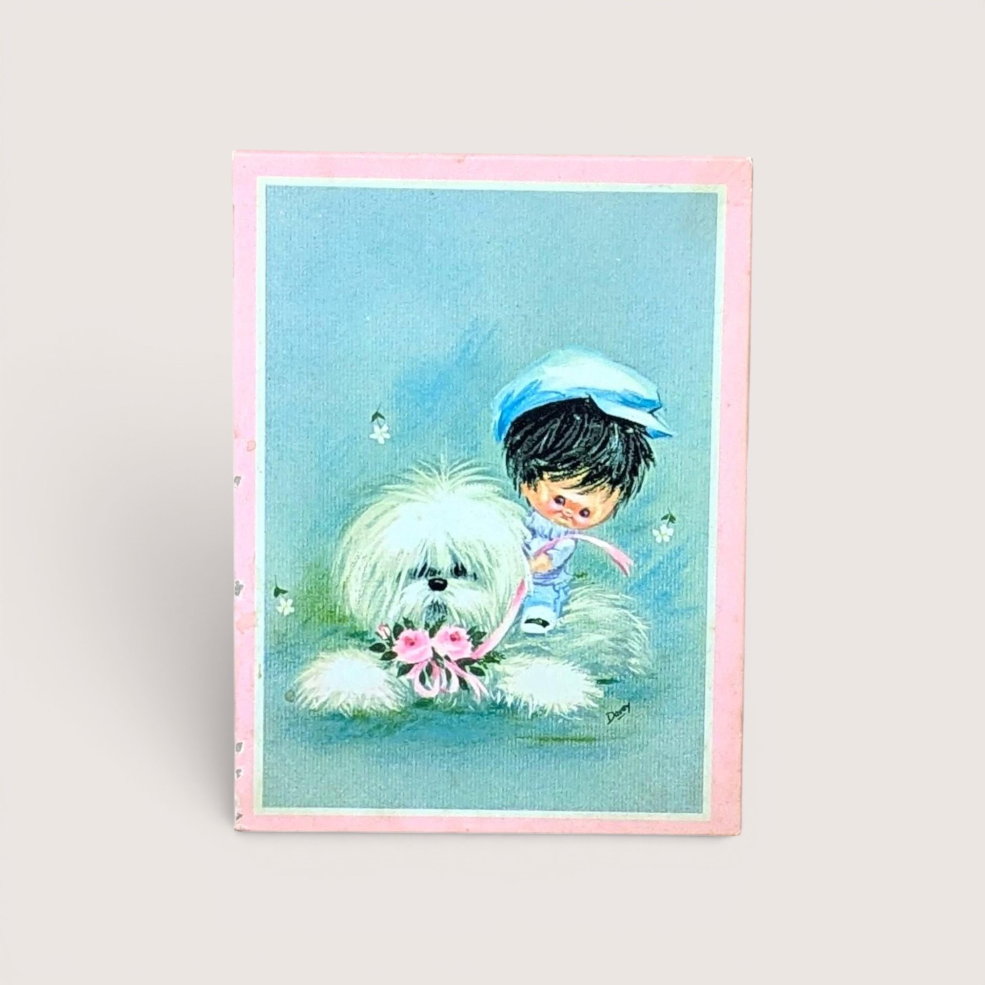 A retro 1960s Darcy big eye illustration card showing a small boy in a blue hat with a fluffy white dog on a blue background.