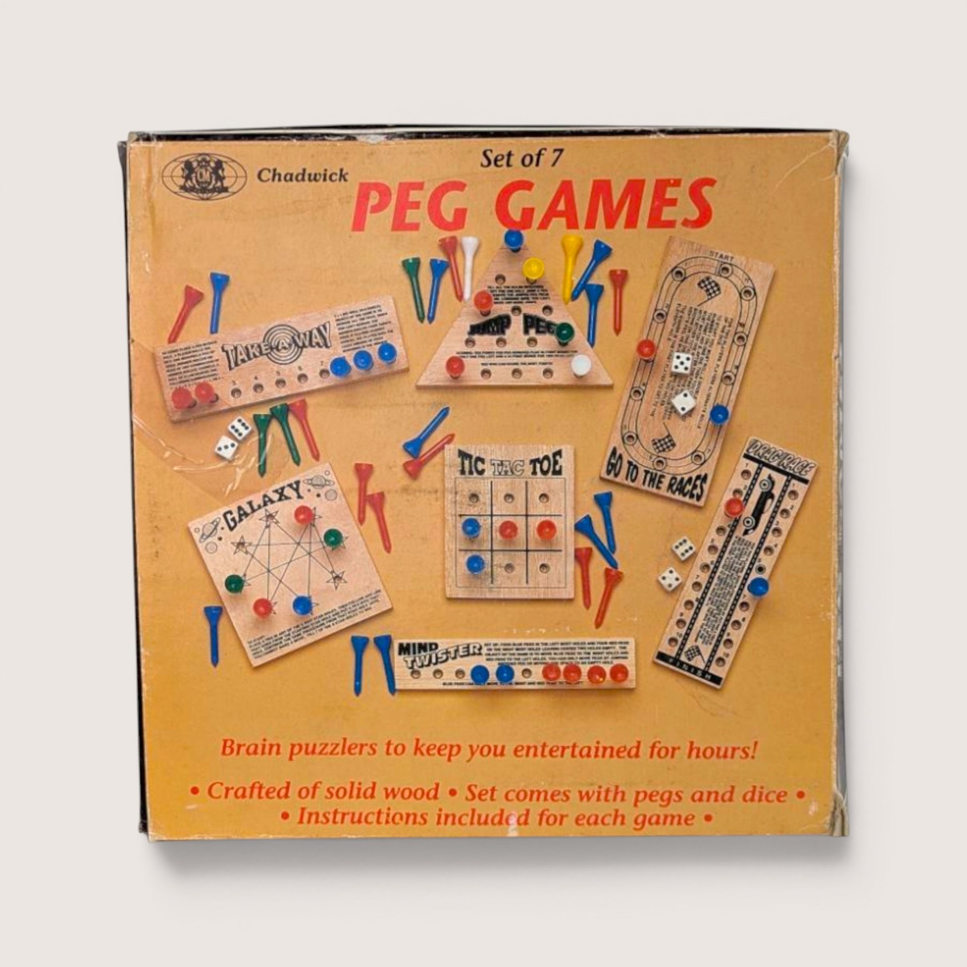Vintage 1980s Chadwick Set of 7 Peg Games in original yellow box with colorful plastic pegs and wooden boards.