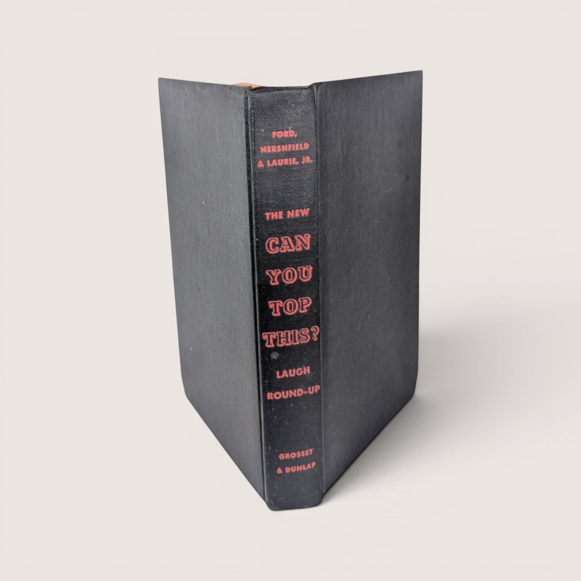 1947 hardcover book spine for The New Can You Top This? Laugh Round-Up in black cloth with orange text.