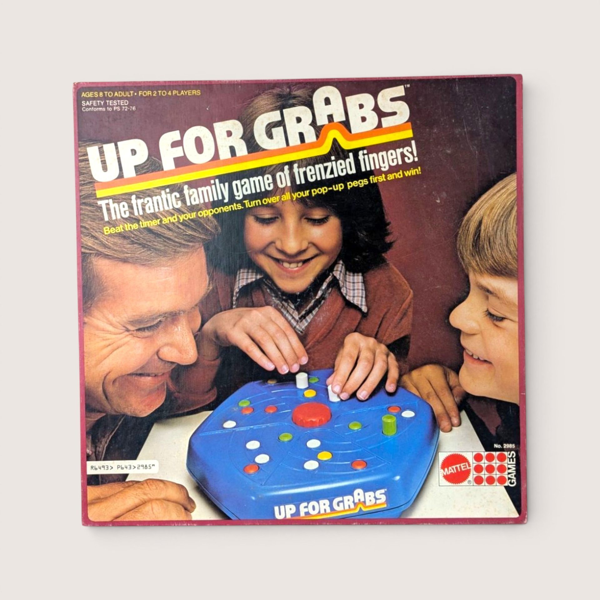 1979 Mattel Up For Grabs vintage board game box cover showing a family playing with a blue plastic peg board.