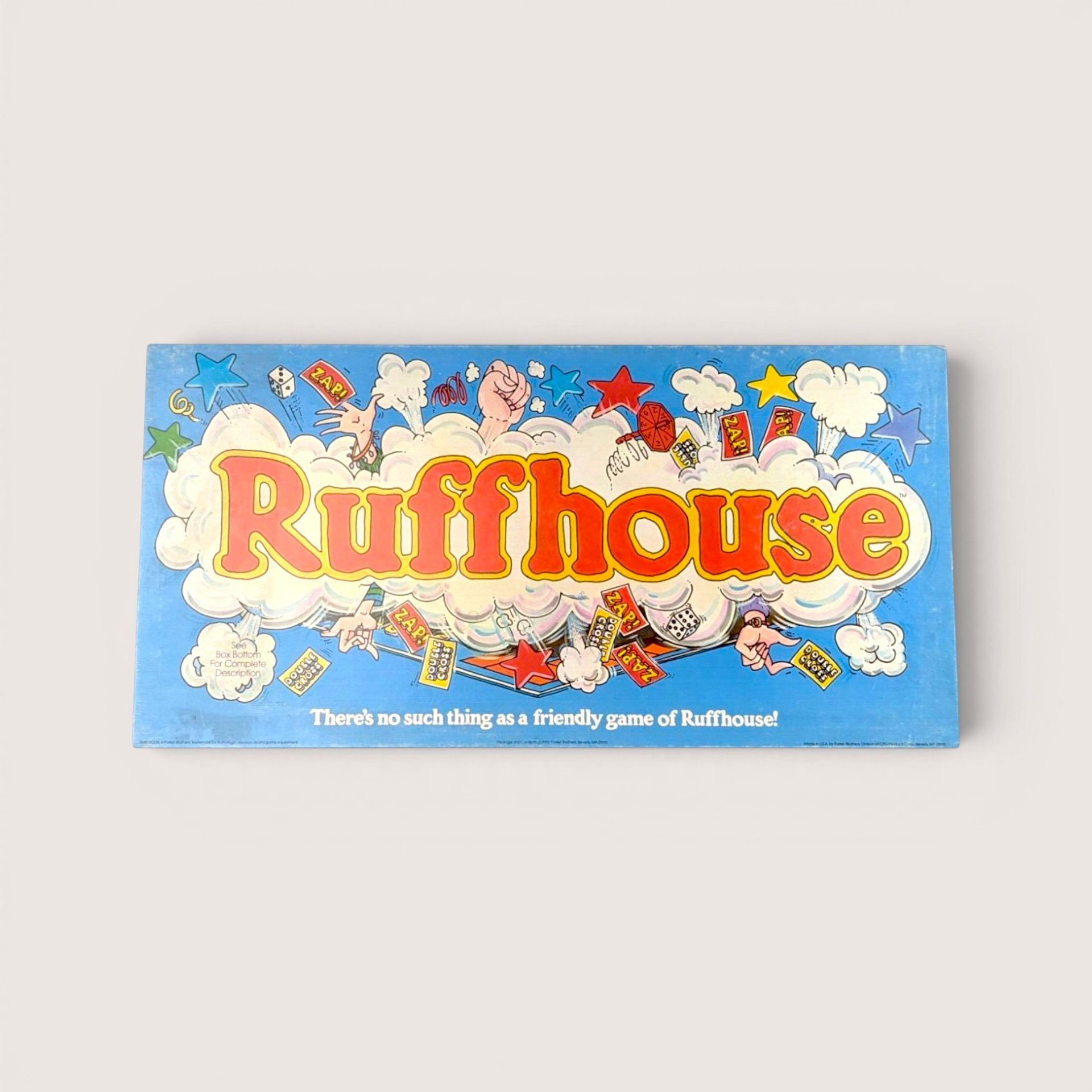 1980 Parker Brothers Ruffhouse vintage board game box featuring bright blue backgrounds and comic book illustrations.
