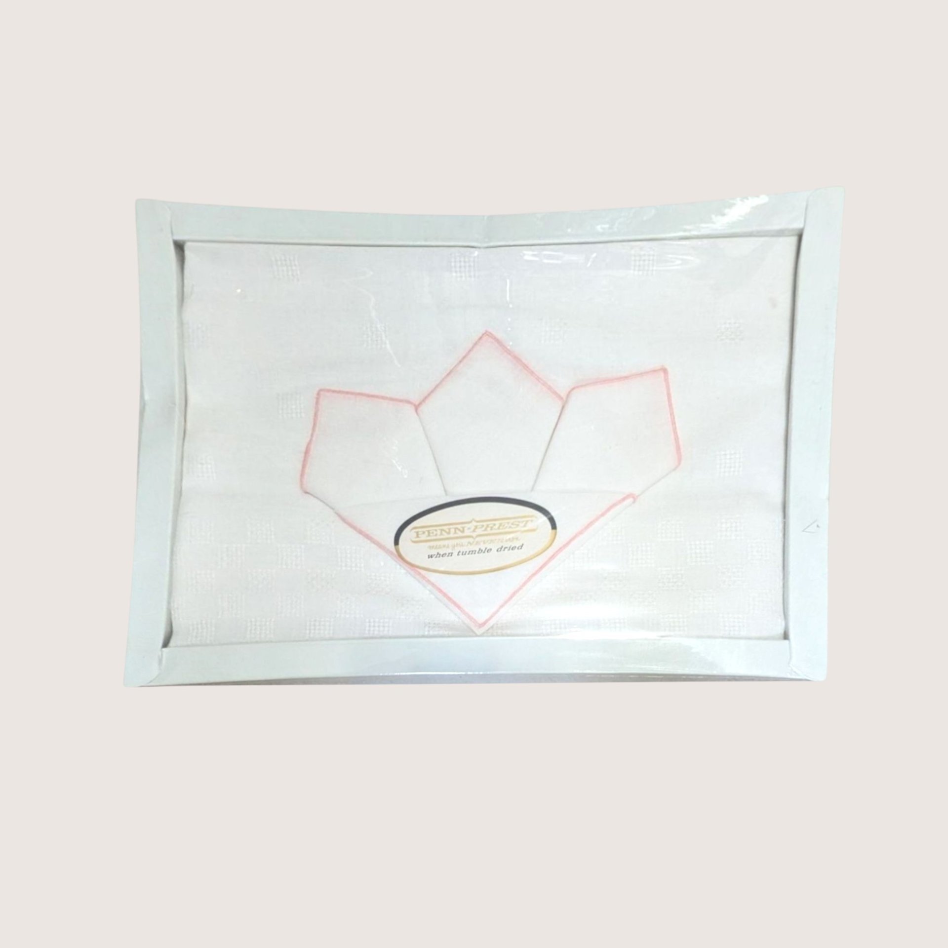 A vintage boxed JCPenney Penn Prest white tablecloth and pink trimmed napkin set sealed in plastic.