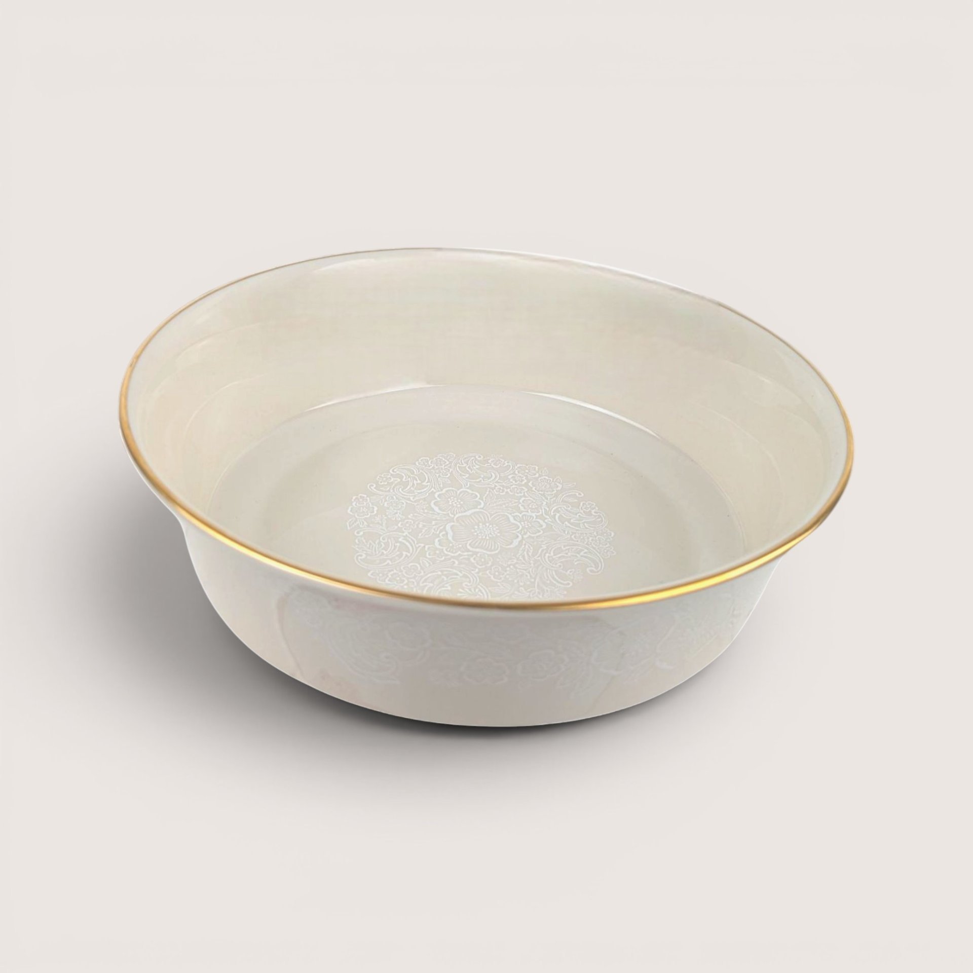 Vintage 1980s Lenox cream porcelain floral lace bowl with gold rim on neutral background.