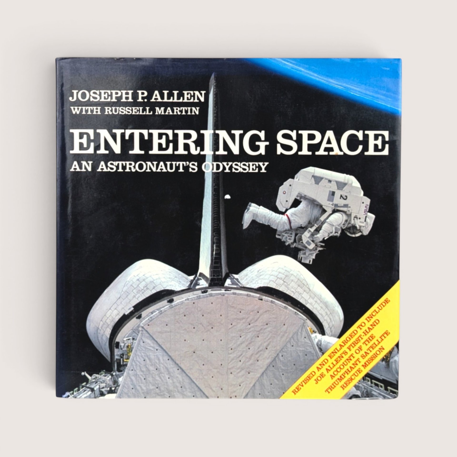 A vintage hardcover copy of Entering Space An Astronaut's Odyssey by Joseph P Allen featuring a space shuttle illustration.