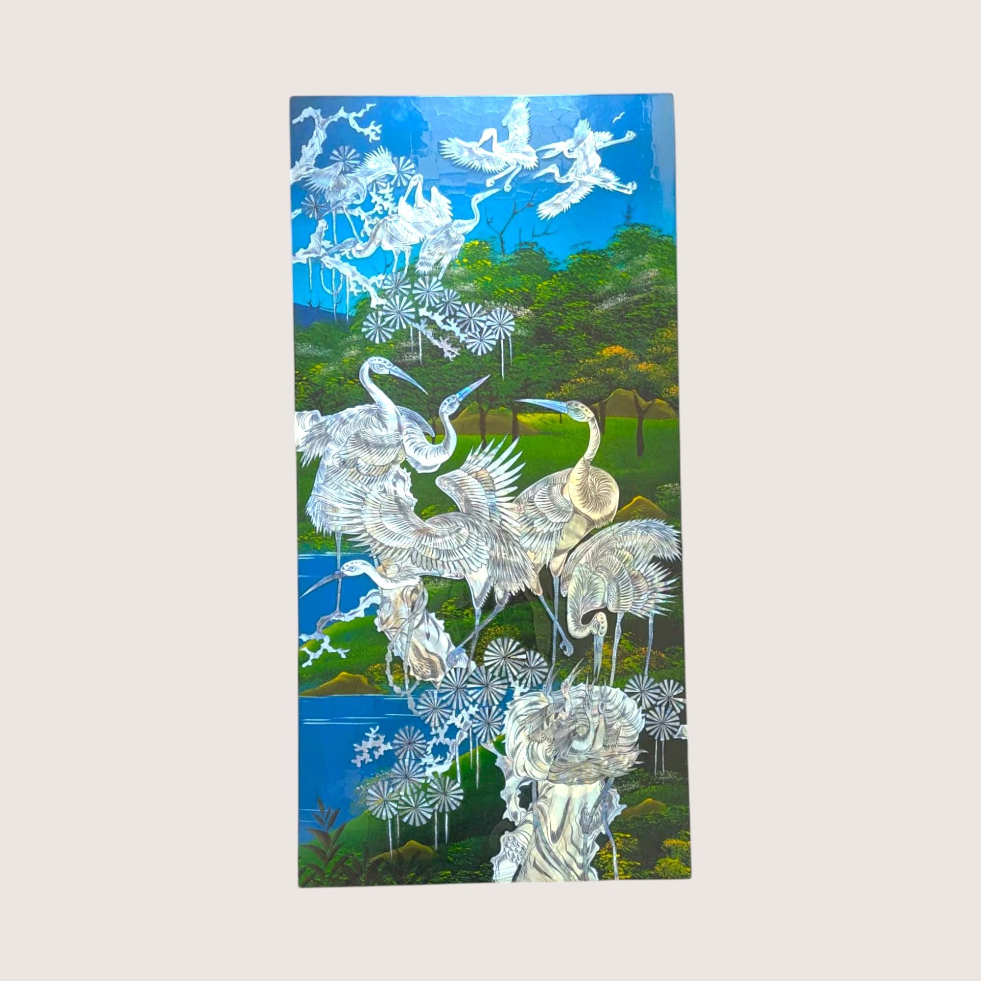 A vintage Asian wall panel featuring cranes amidst trees and water inlaid with mother of pearl.