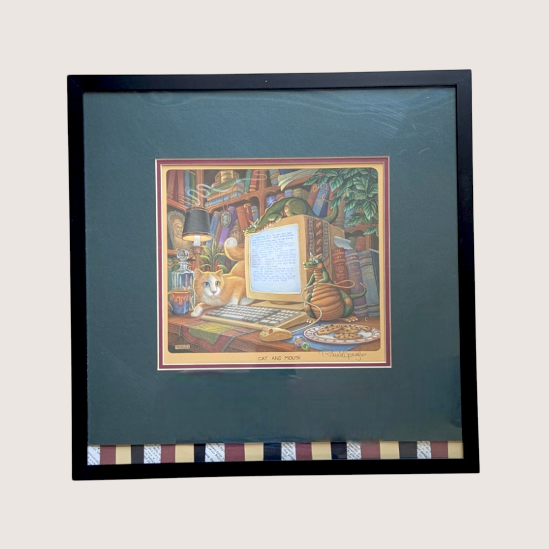 A framed vintage Randal Spangler whimsical print titled Cat and Mouse featuring a calico cat and small dragons at a computer desk.A framed vintage Randal Spangler whimsical print titled Cat and Mouse featuring a calico cat and small dragons at a computer desk.