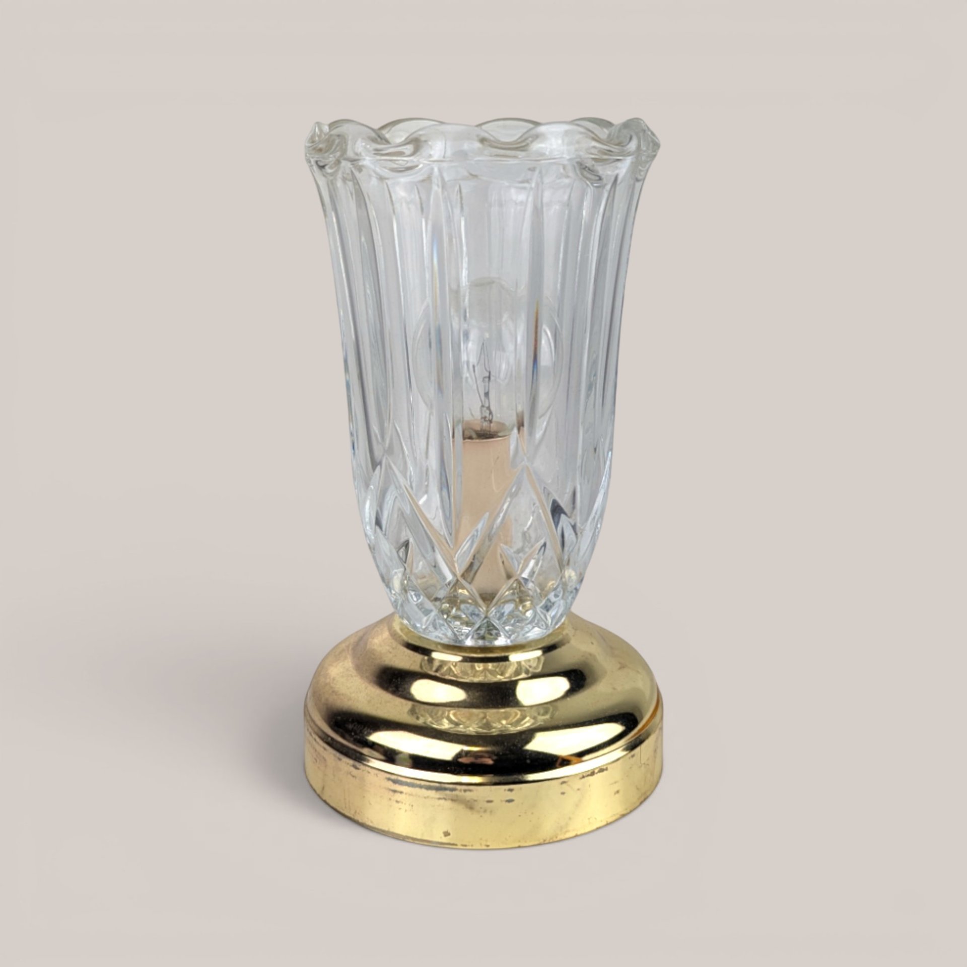 Vintage small clear glass and brass accent lamp with a fluted shade design and a visible interior bulb.