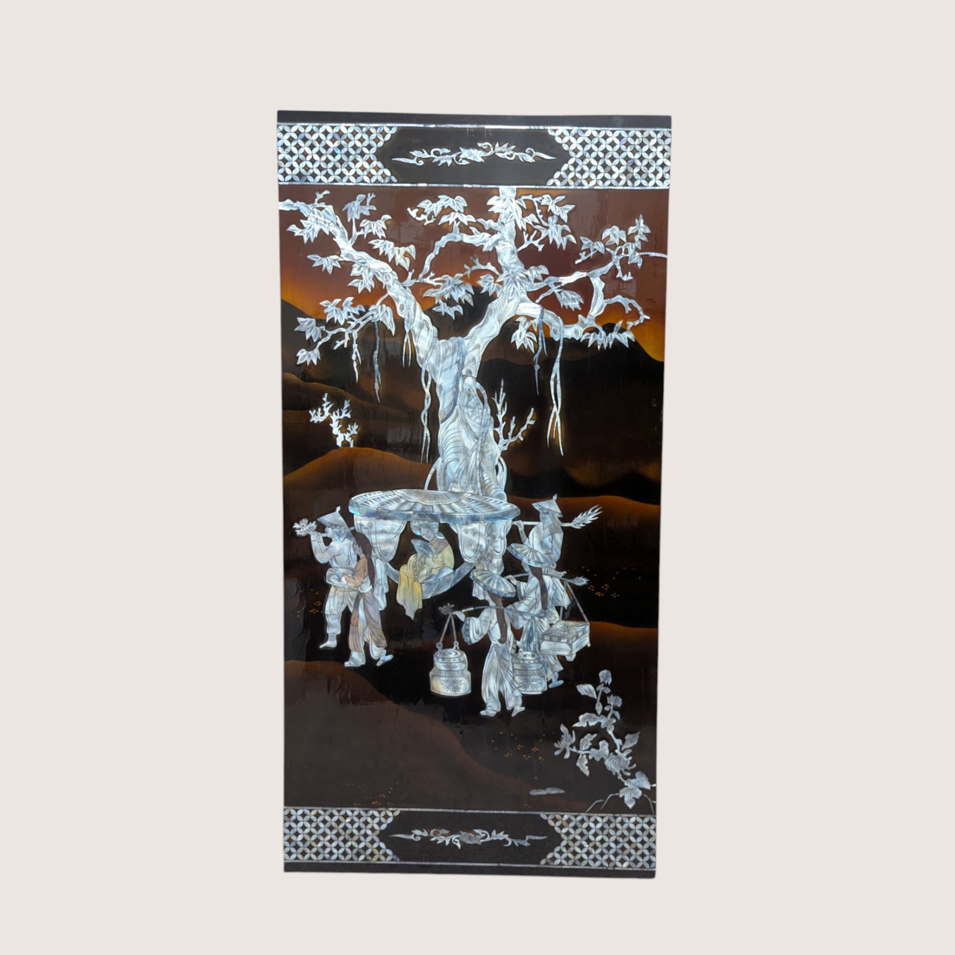 A large rectangular black lacquer wall panel featuring a detailed mother of pearl inlay scene under a large tree.