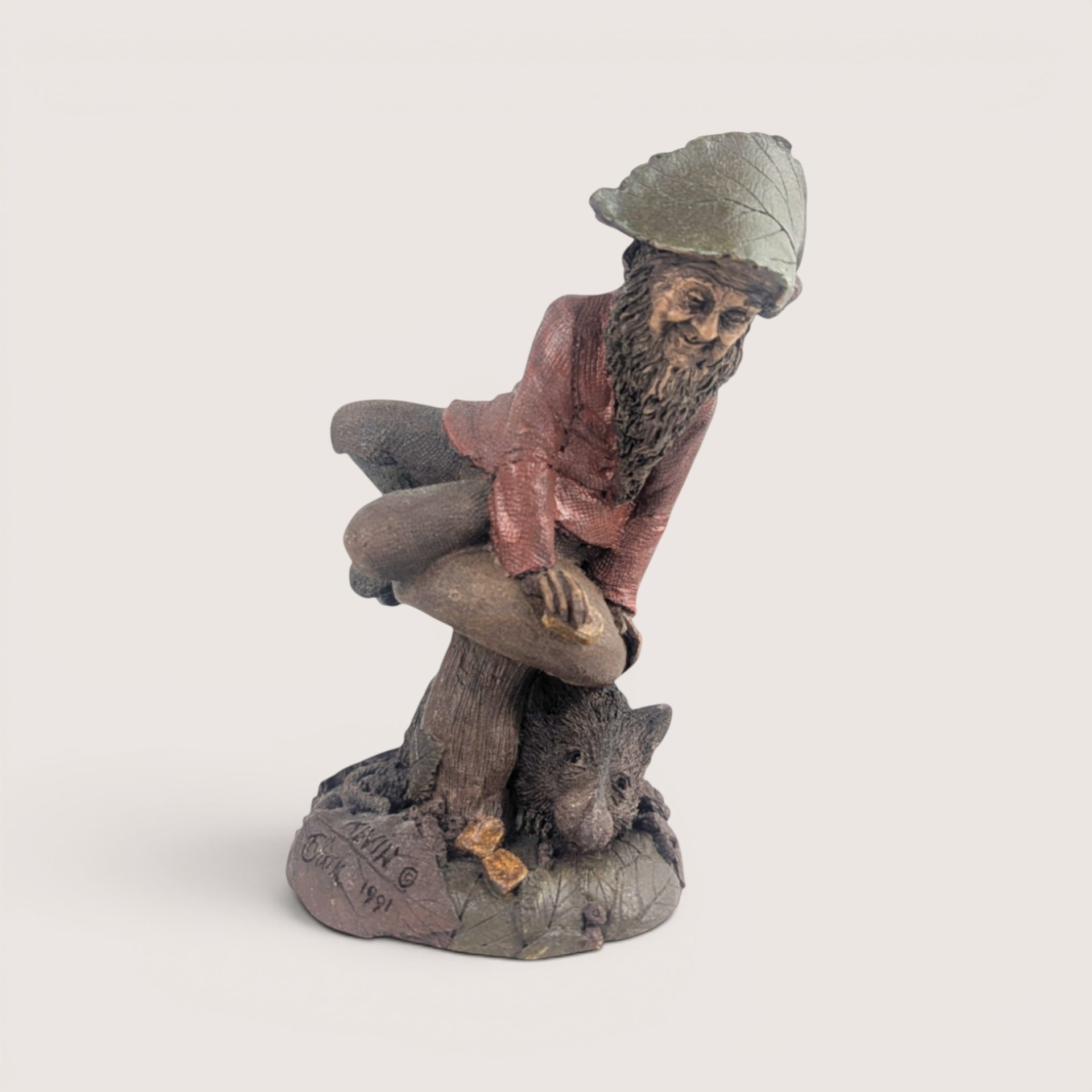 A vintage Tom Clark Cairn Studios resin gnome figurine titled Kevin featuring a gnome on a mushroom base next to a small animal.