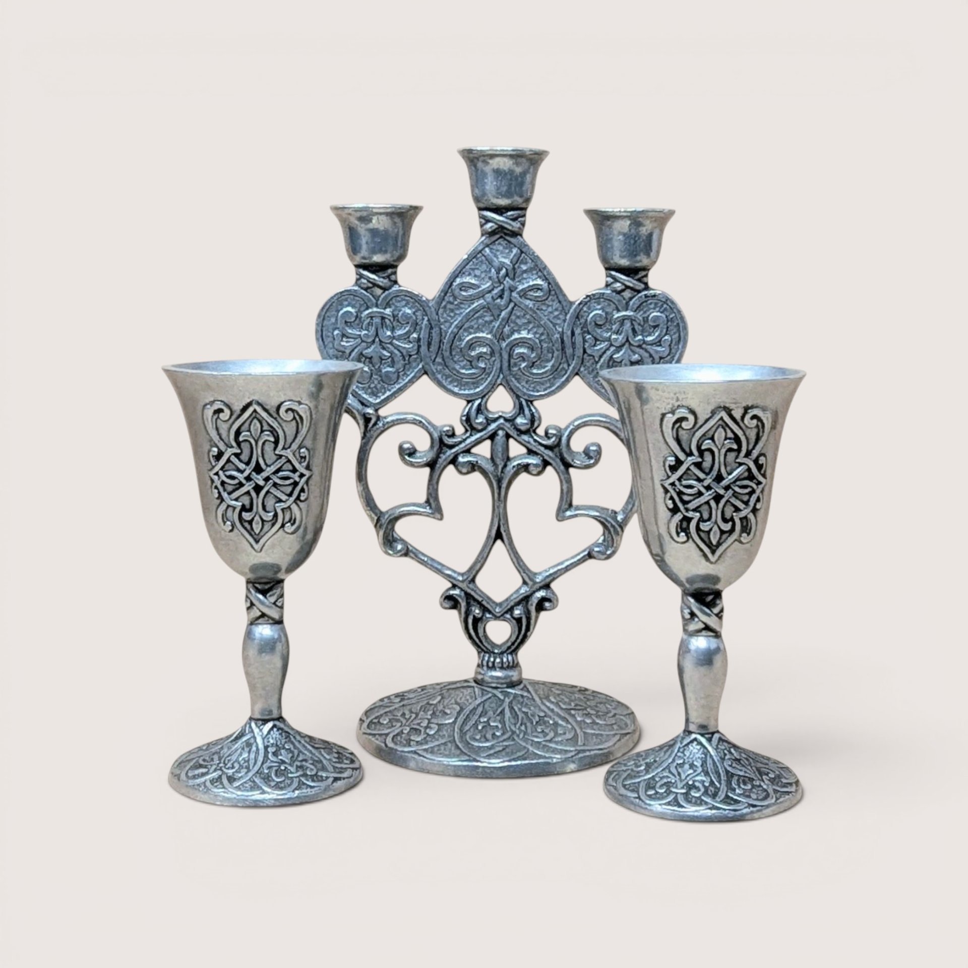 Vintage Carlson Forevermore pewter set consisting of an ornate multi-candle candelabra flanked by two matching goblets with intricate relief patterns.