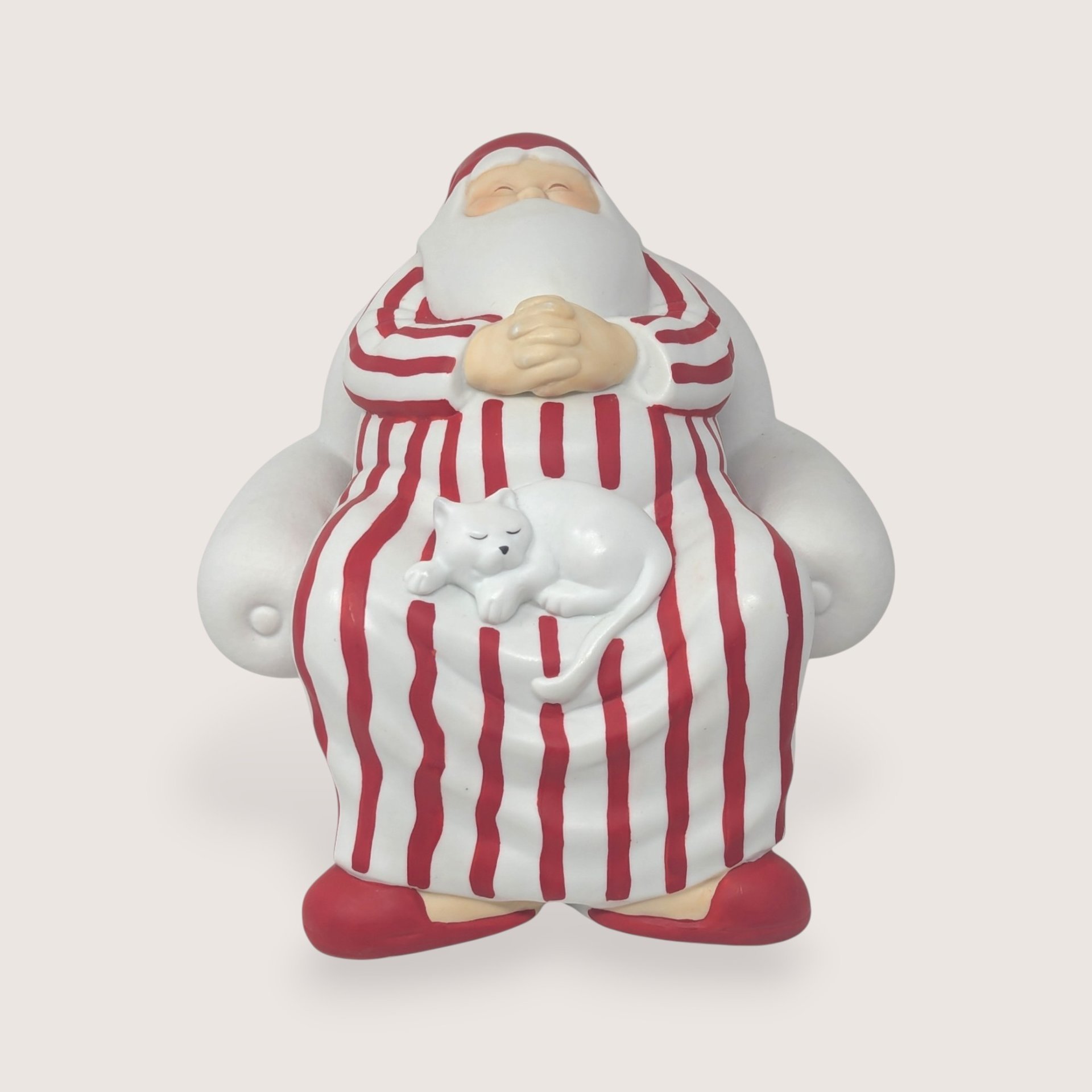 Vintage 1990s Dept 56 matte white bisque porcelain Santa in red striped pajamas with a sleeping white cat on his lap.  
