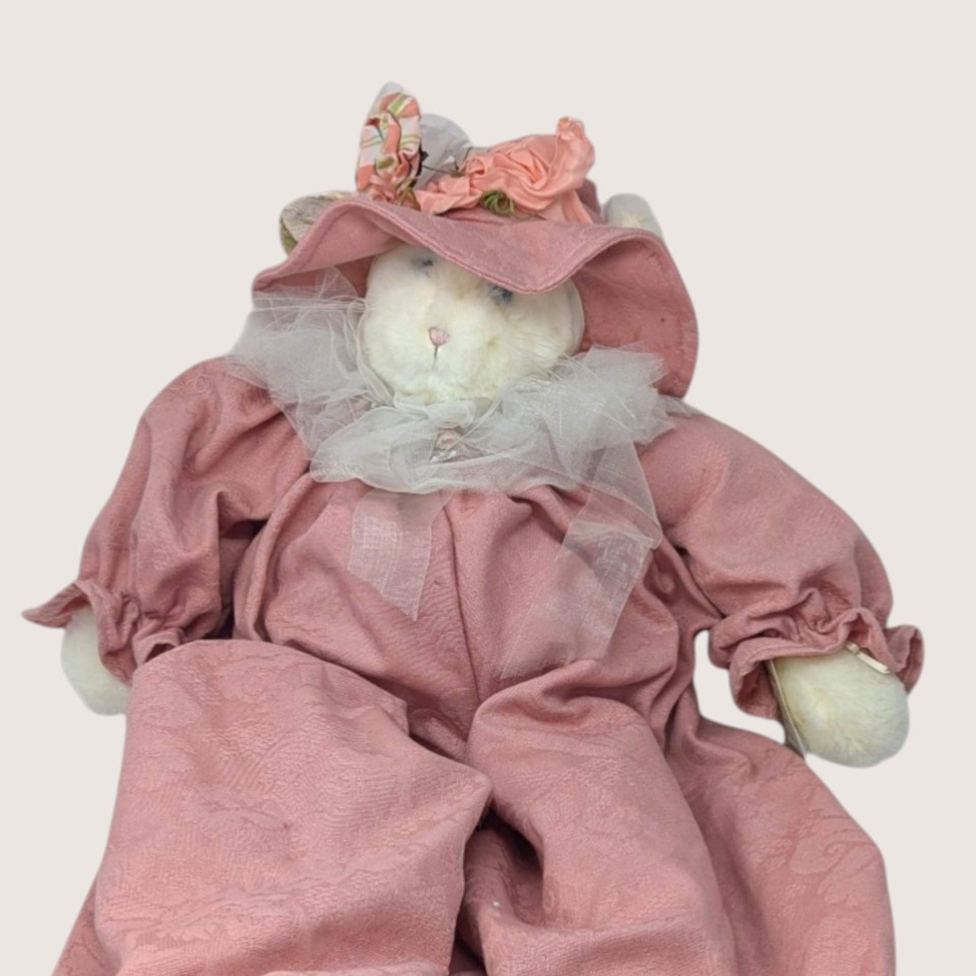 A large vintage 1994 Bunnies By the Bay plush artisan cat doll named Jolie wearing a dusty rose romper and hat.
