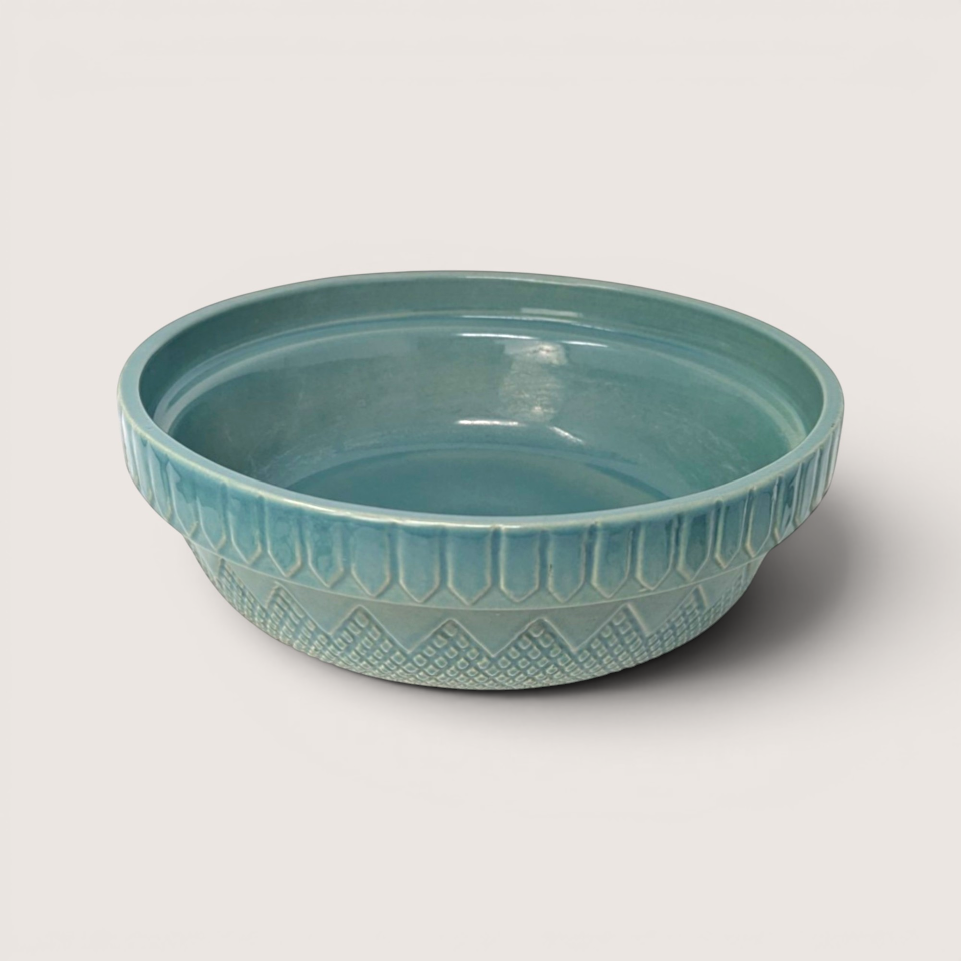 Vintage teal blue Coche Portugal stoneware serving bowl with geometric relief patterns on the exterior sides.