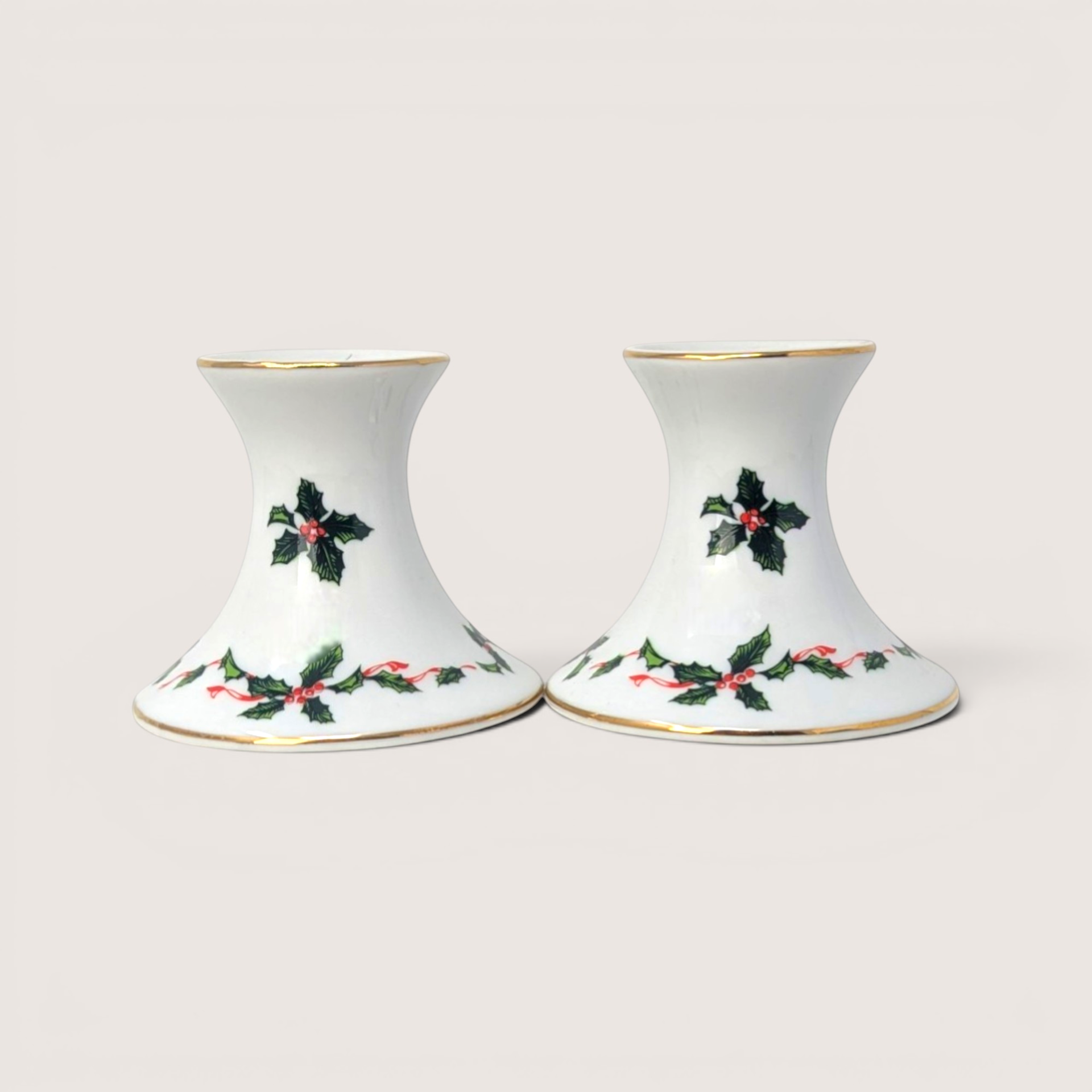 Pair of vintage Lefton white ceramic candlestick holders decorated with holly berries and a gold rim.
