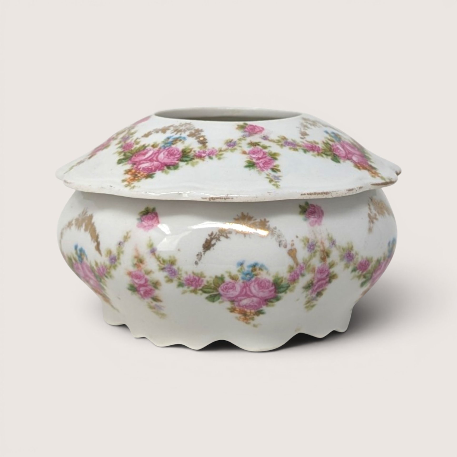 Antique M.Z. Austria porcelain hair receiver jar decorated with pink floral swags and a scalloped base.