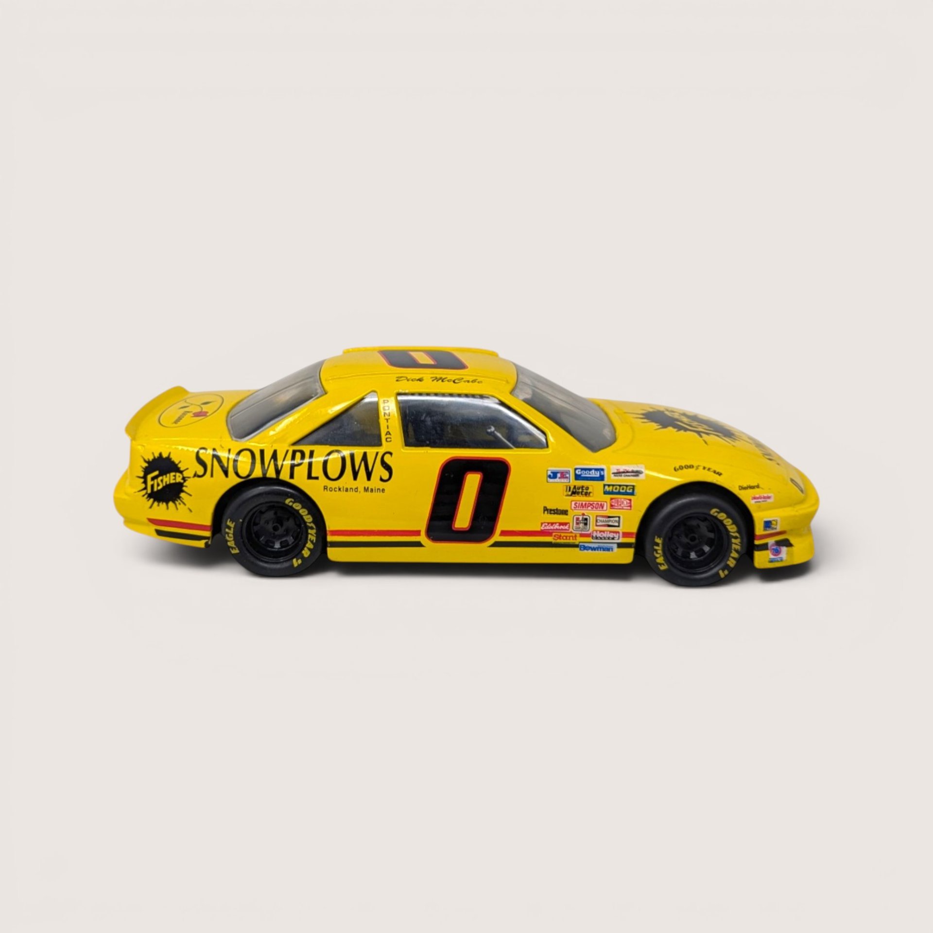 Packaged 2003 Racing Champions 1:24 scale diecast replica of the yellow number 0 Fisher Snowplows Pontiac Grand Prix.