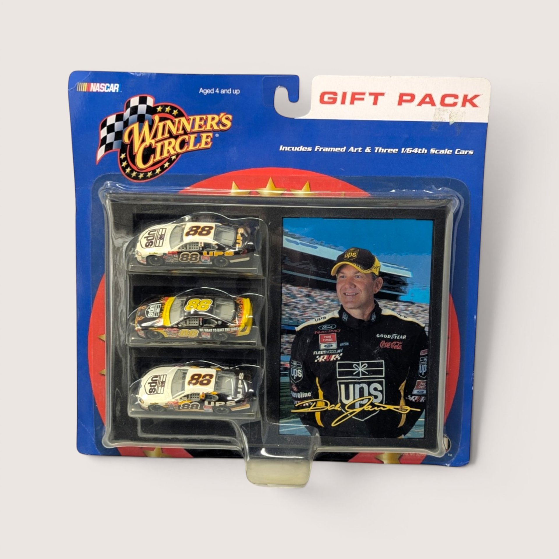 Vintage Winner's Circle NASCAR gift pack featuring three 1/64 scale Dale Jarrett #88 UPS cars and framed photo sealed in package.