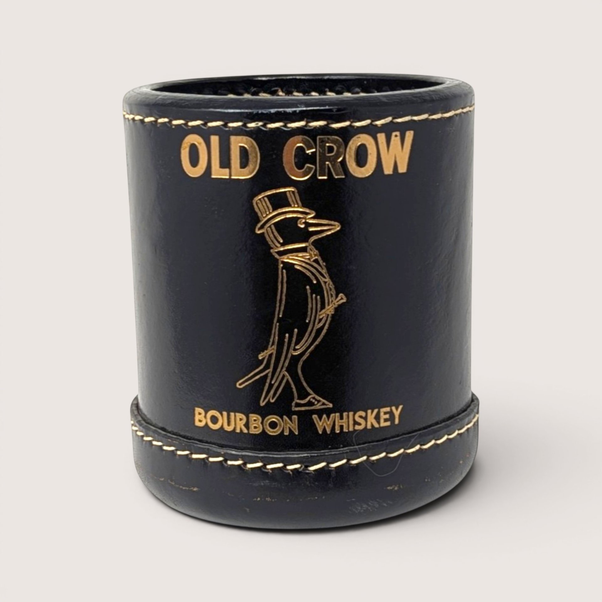 Vintage black leather Old Crow Bourbon Whiskey promotional dice cup embossed with gold foil lettering and crow mascot.