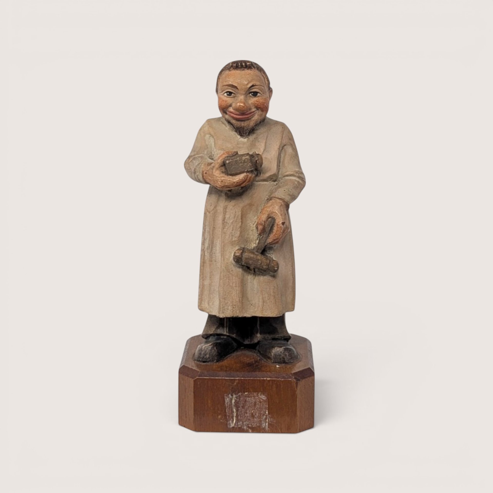 Vintage 1950s Anri Toriart hand-carved wooden apothecary figurine holding medical tools on an octagonal base.