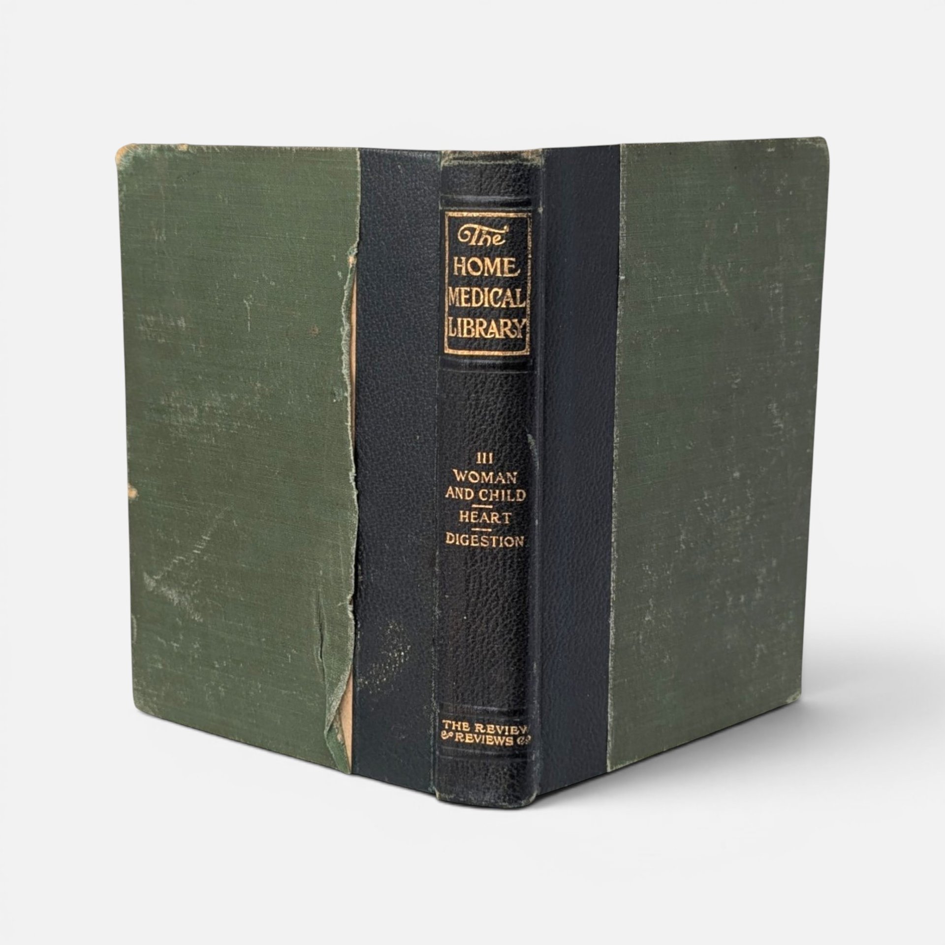 Vintage 1907 hardcover copy of The Home Medical Library with a dark spine and green covers.
