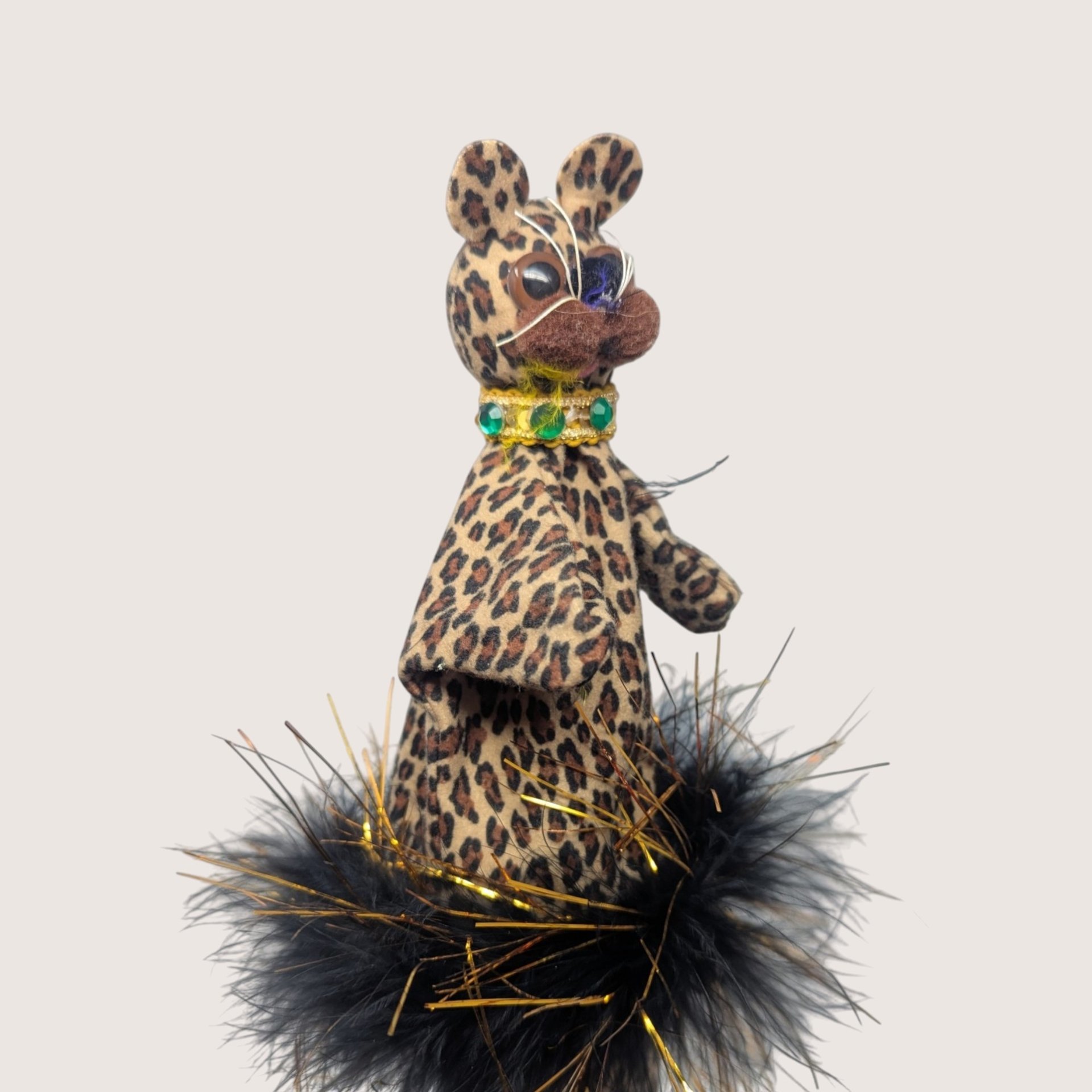 Vintage handmade felt leopard stick puppet in leopard print with a black feather boa collar and wooden rod.