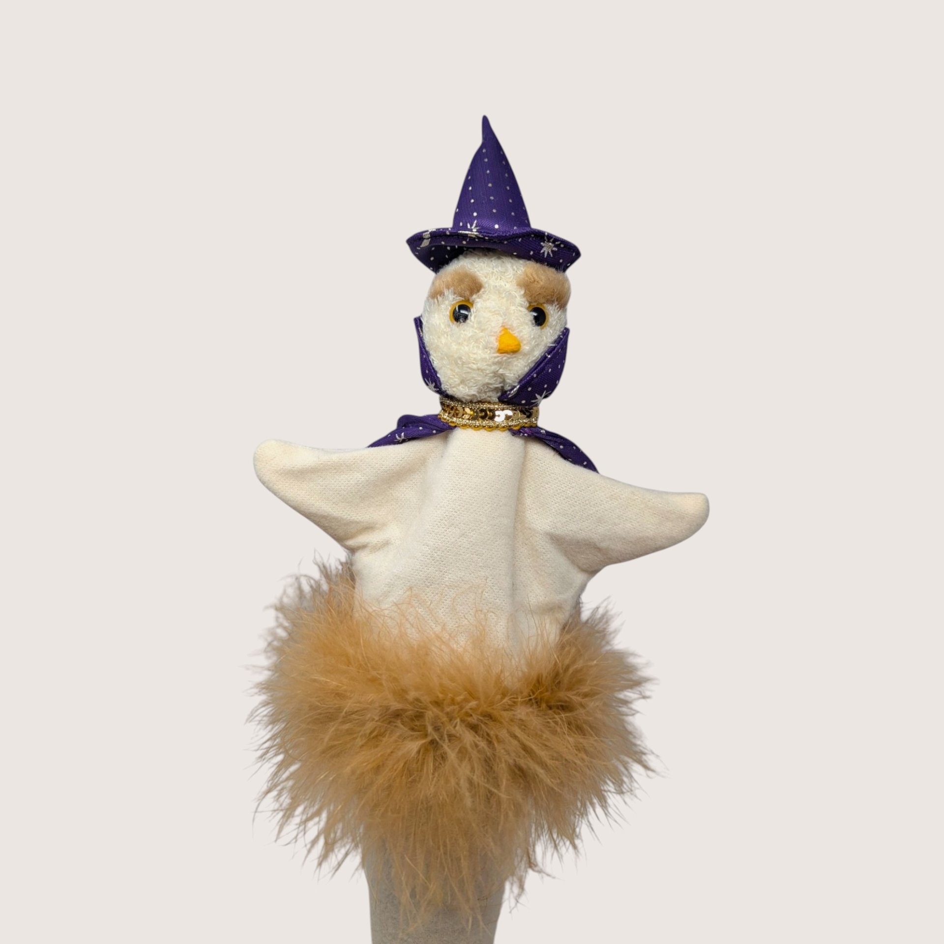 Vintage handmade felt wizard bird stick puppet wearing a purple star-print hat and cape with a feather boa base.
