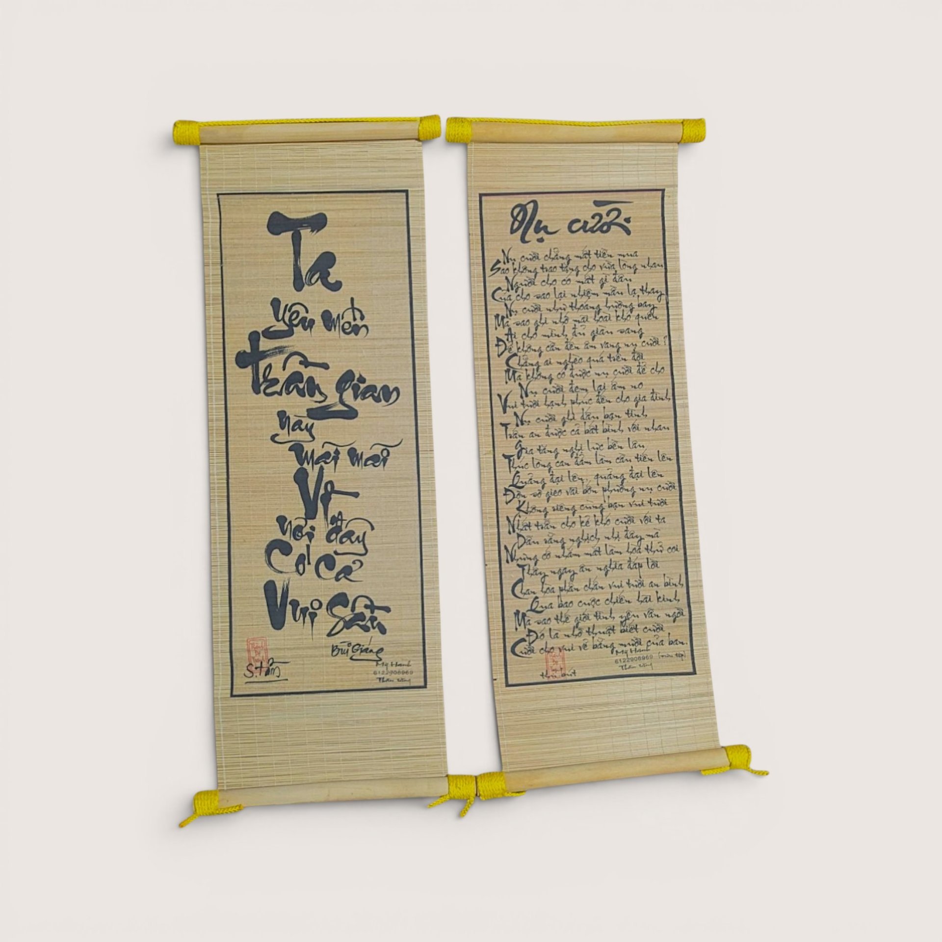Vintage Vietnamese bamboo scroll set with black calligraphy script and red seal stamps against a neutral background.