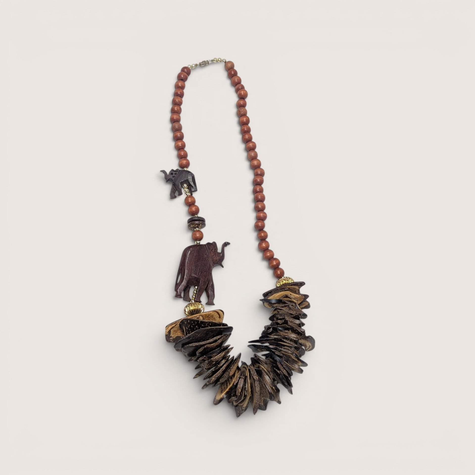 Vintage wooden statement necklace featuring carved wooden elephants and cascading wood chip beads
