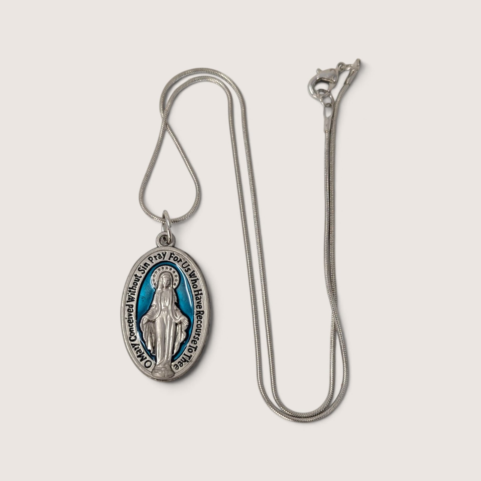 Vintage silver-tone Miraculous Medal pendant necklace with blue enamel background and 18-inch chain.