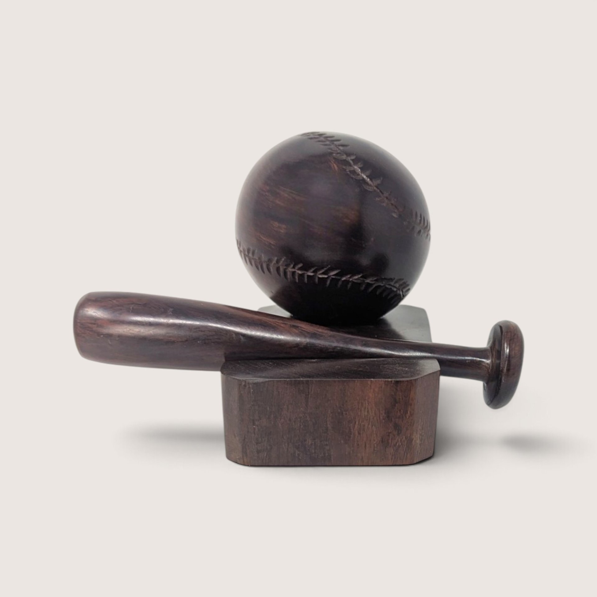 Vintage hand-carved wooden baseball and bat display figurine on a dark wood block base.