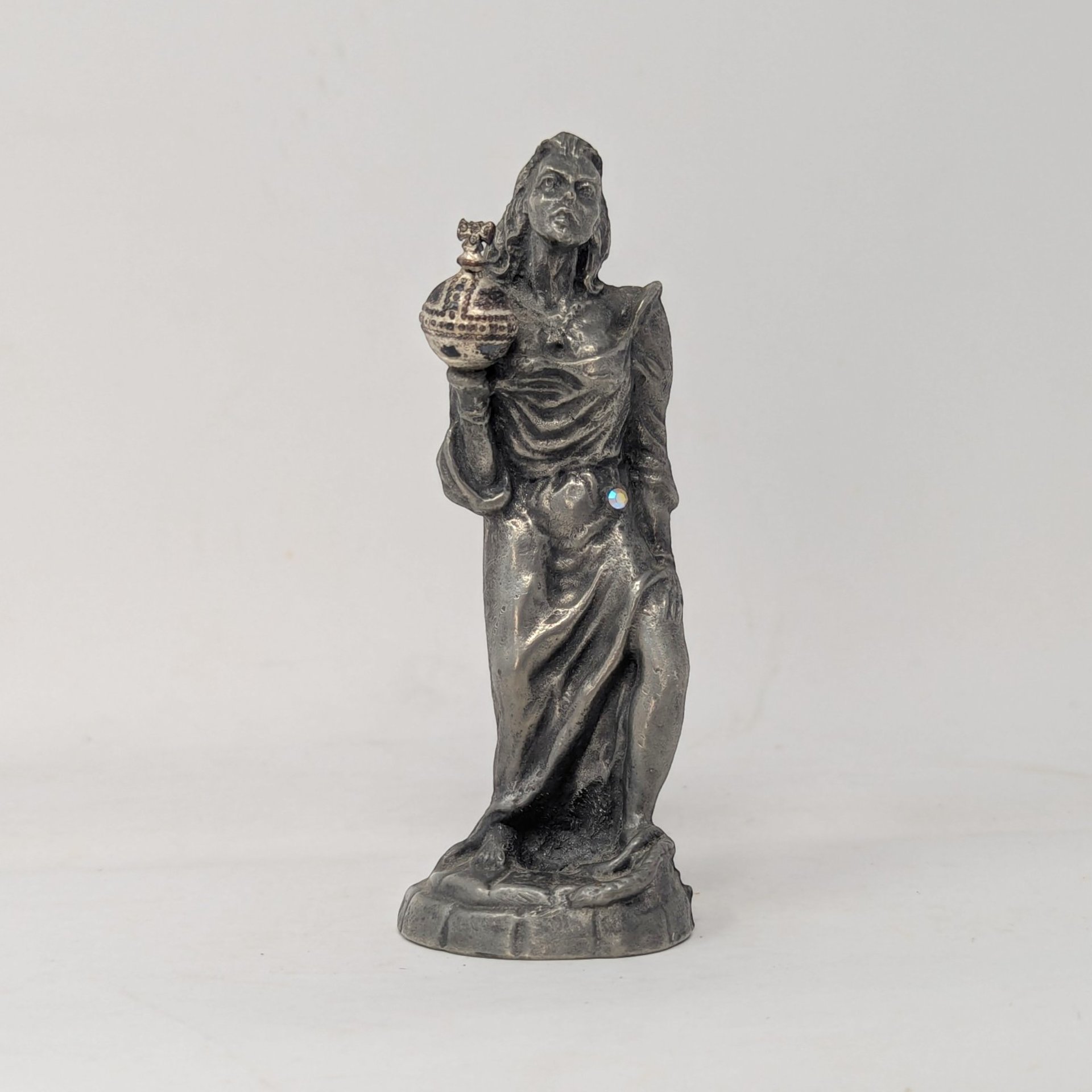 Front view of a vintage Weatherby pewter sovereign figurine holding an ornate orb with a rhinestone accent.
