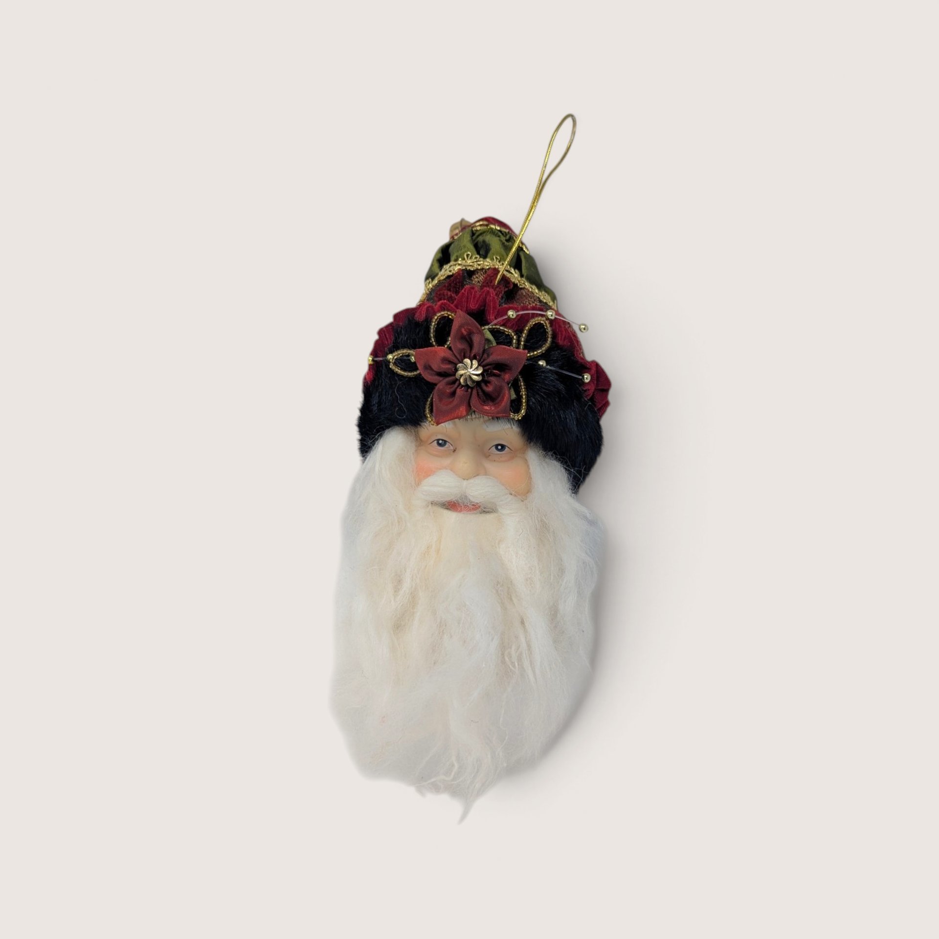 Vintage Santa head Christmas tree ornament with an ornate velvet hat and a red flower detail.