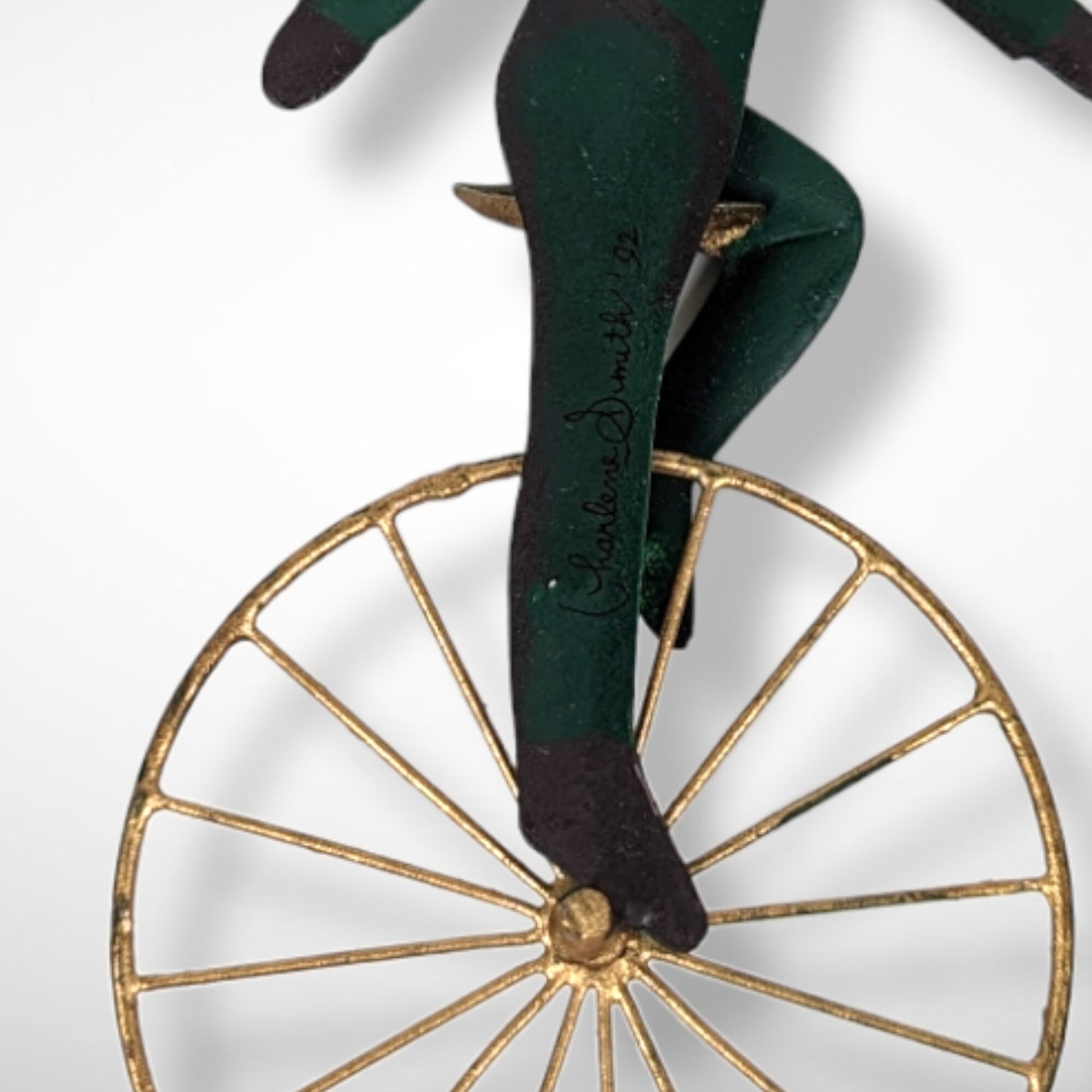 1992 Charlene Smith Signed Metal Ornament of Santa on a Unicycle