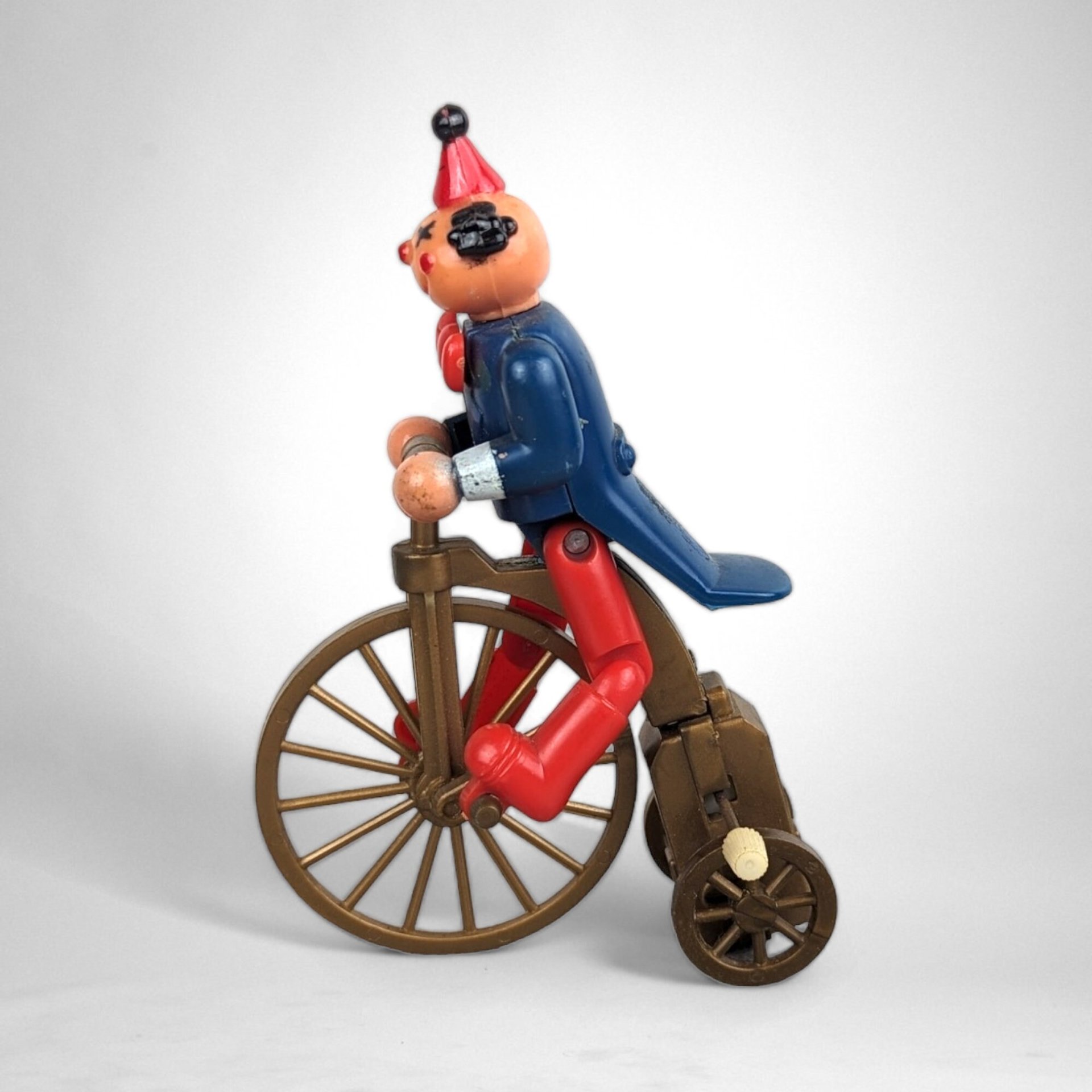 Vintage Plastic Clown on Bicycle Wind-Up Toy: Whimsical Collectible