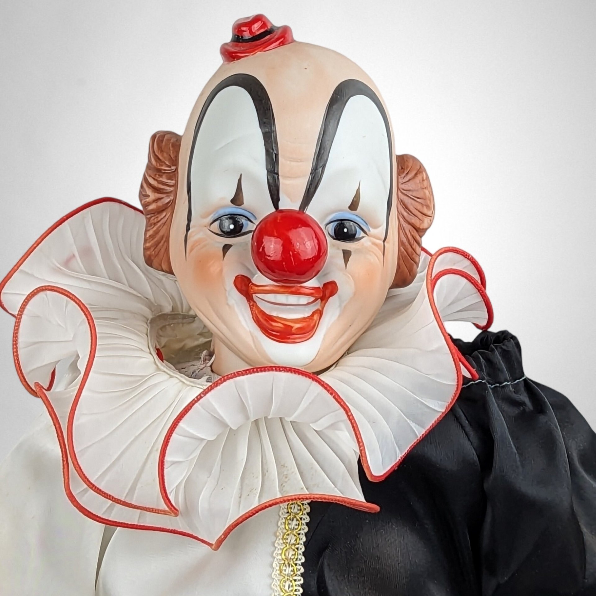 Porcelain Musical Sitting Clown Doll: Whimsical Melody and Delightful Decor