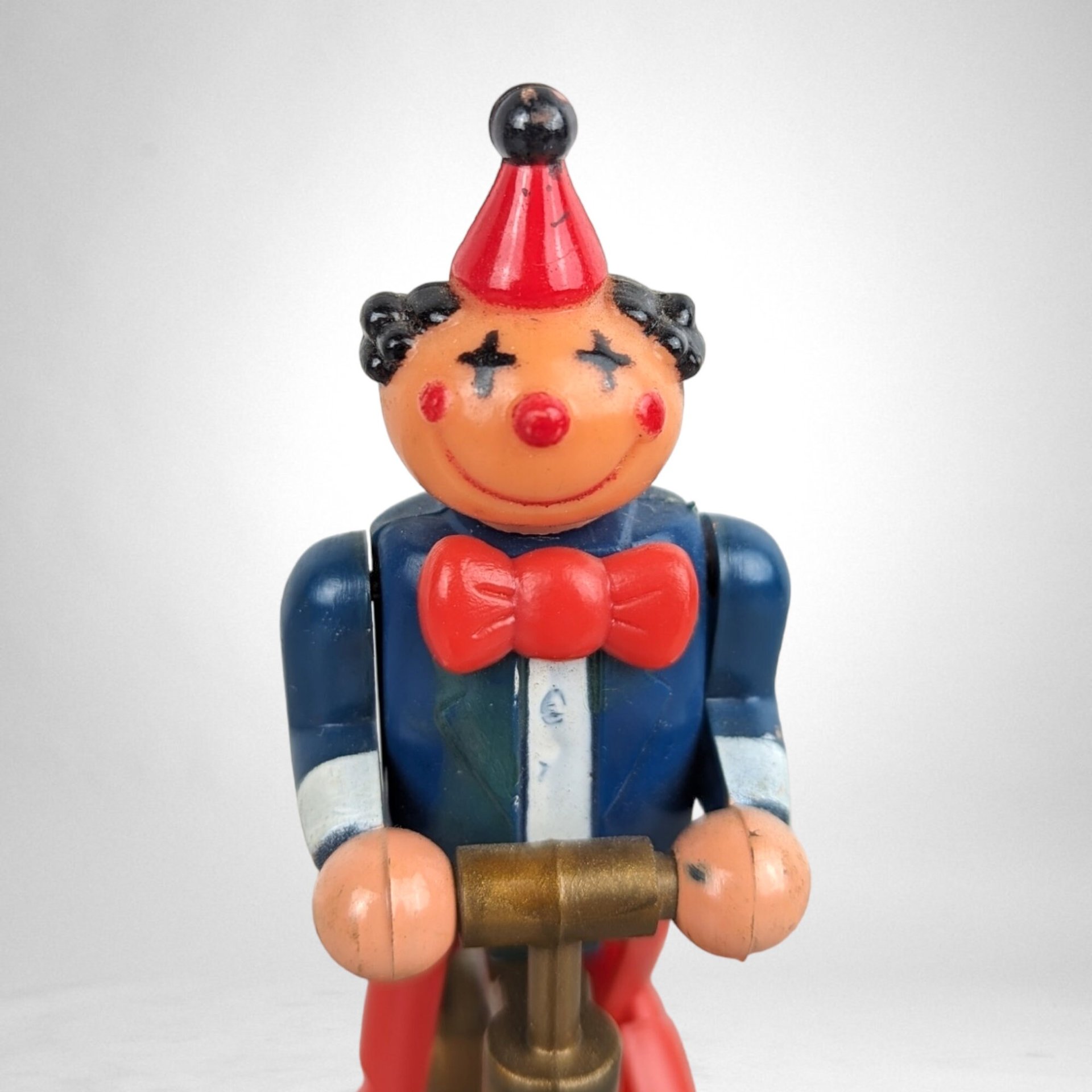 Vintage Plastic Clown on Bicycle Wind-Up Toy: Whimsical Collectible