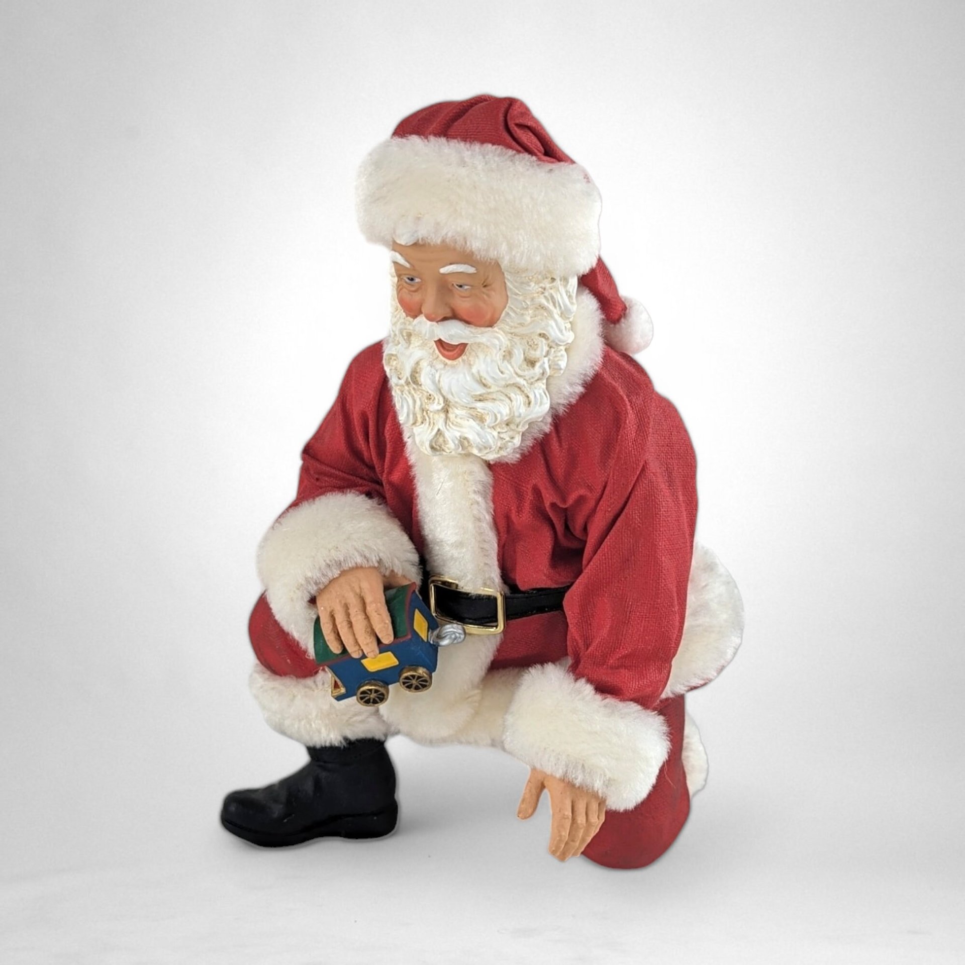 Vintage Fabriche Santa Kneeling Holding Toy Train Figure – Timeless Holiday Delight