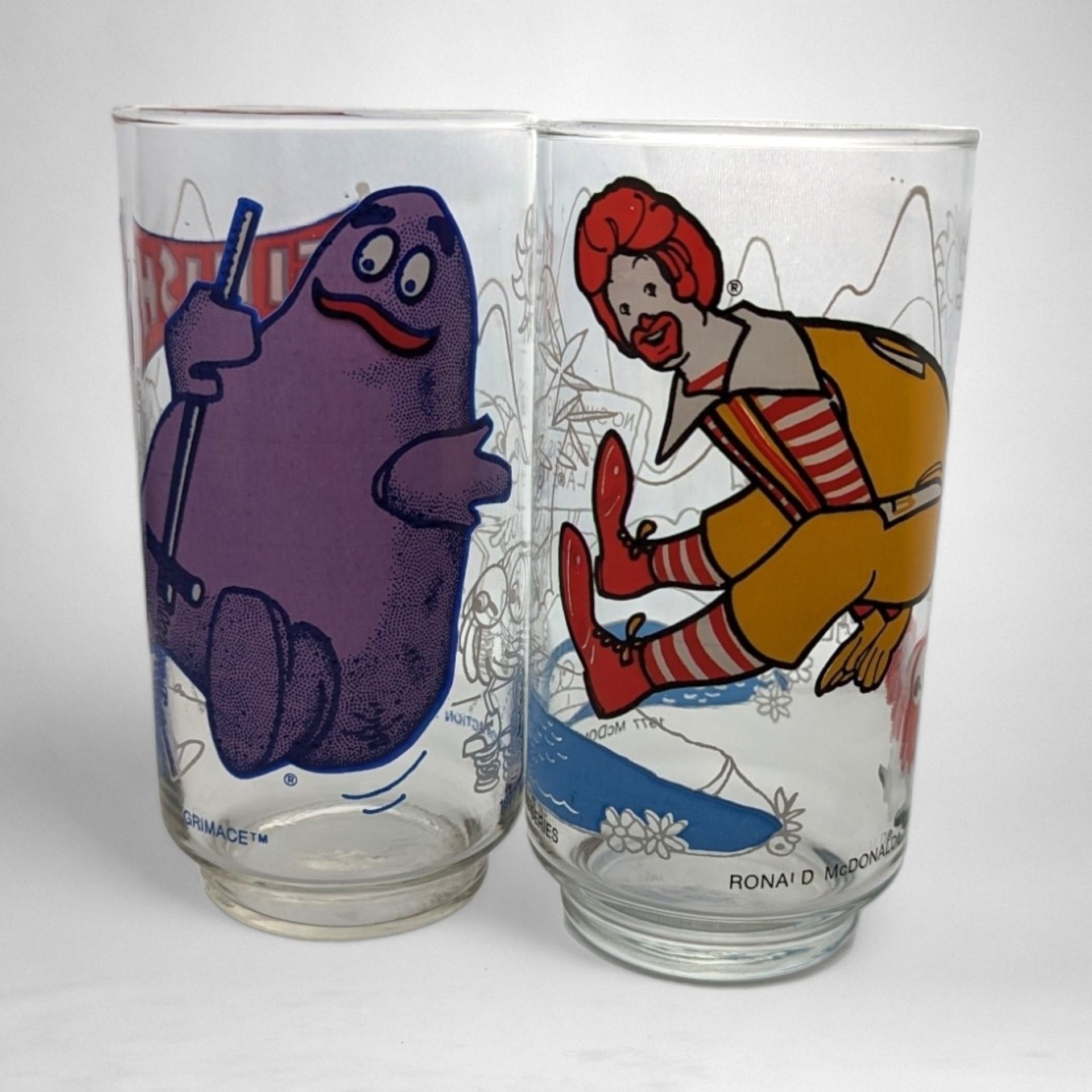 Pair of 1977 McDonald's Action Series Collectible Glasses - Retro Fast Food Memorabilia