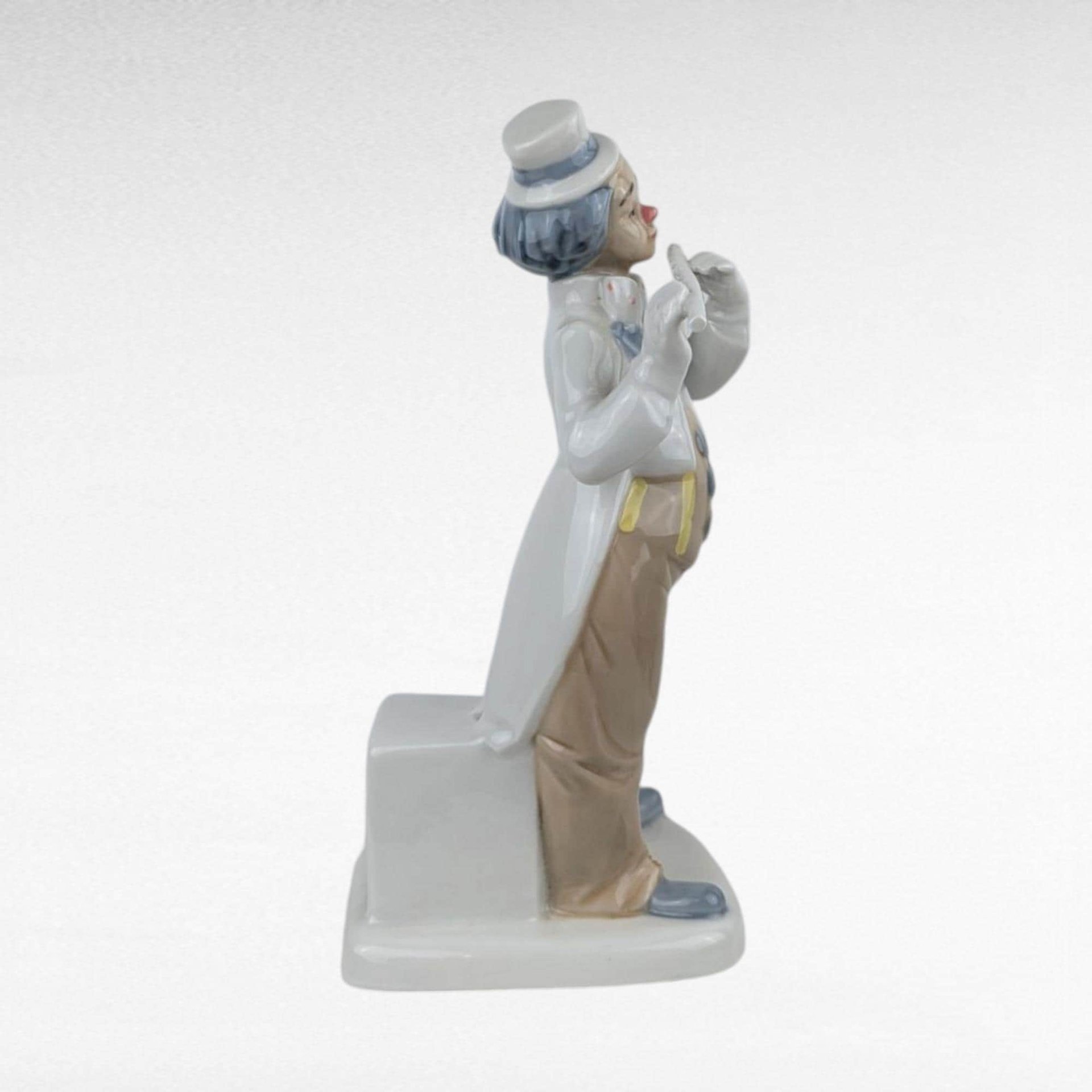 Vintage Porcelain clown figurine holding a flute.
