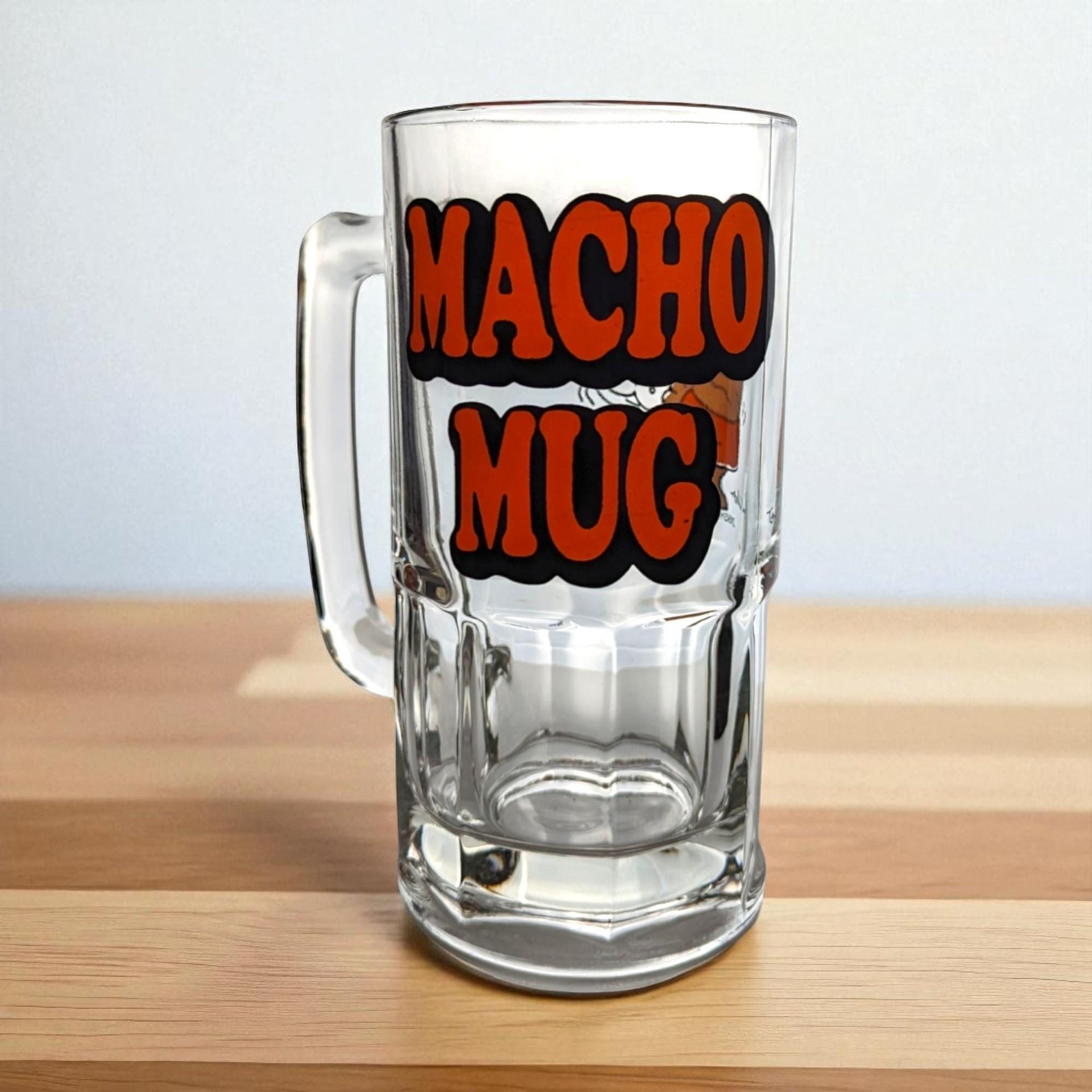 A large, heavy clear glass beer mug featuring a colorful 1979 illustration of the cartoon character Ziggy holding a foaming mug of beer with the word Macho printed above him.