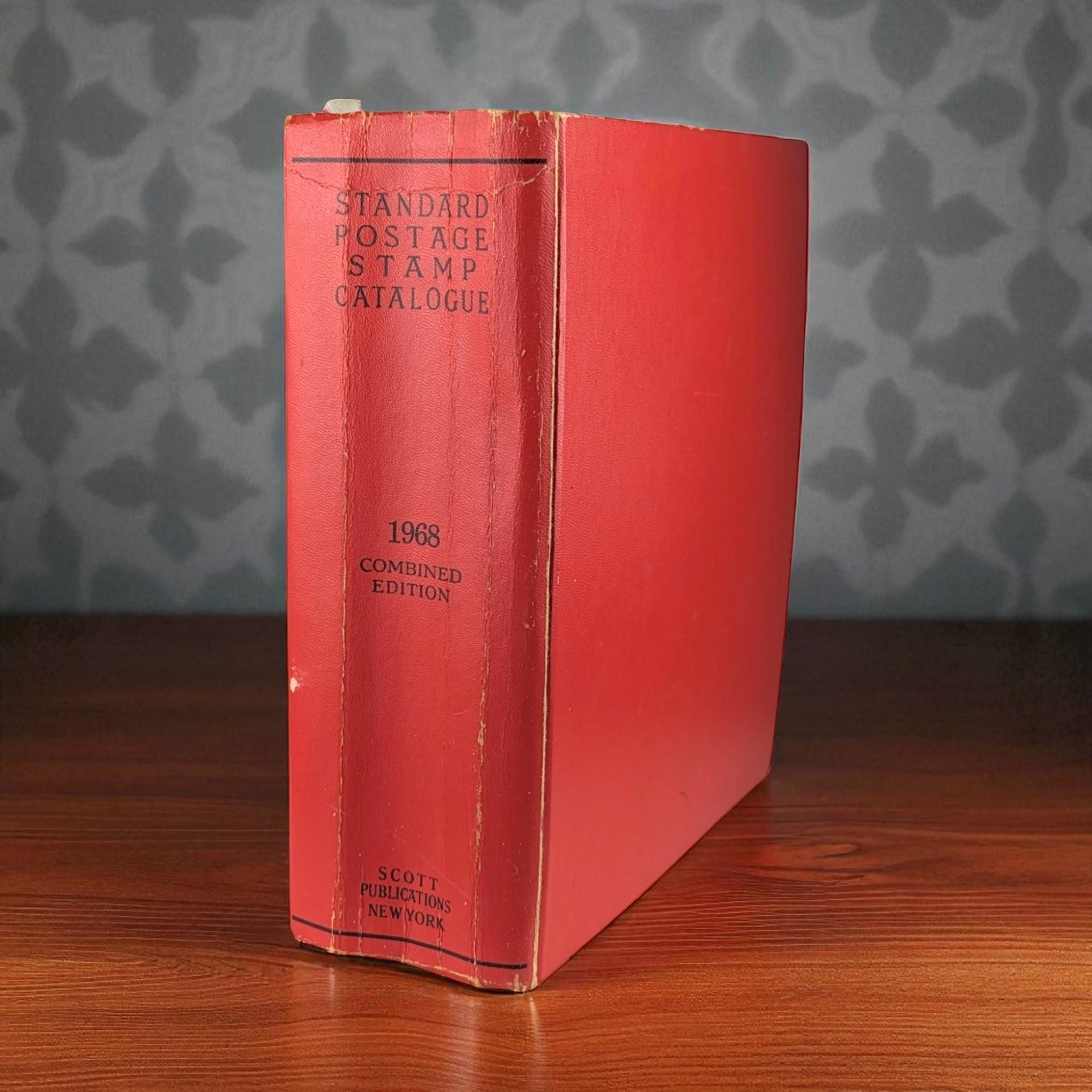 A thick, red hardcover book titled "Standard Postage Stamp Catalogue 1968 Combined Edition" by Scott Publications New York, shown from a side angle highlighting its substantial 1367-page spine.